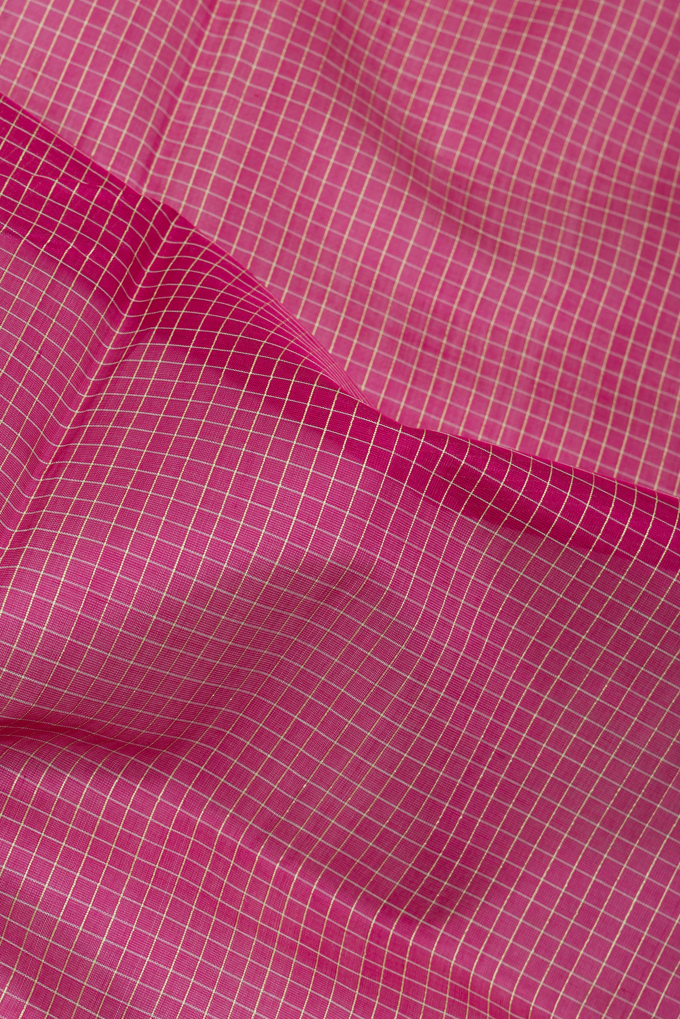Close up of Pink Silk Cotton Saree with Checked design on the body and Plain Border.  displaying folds