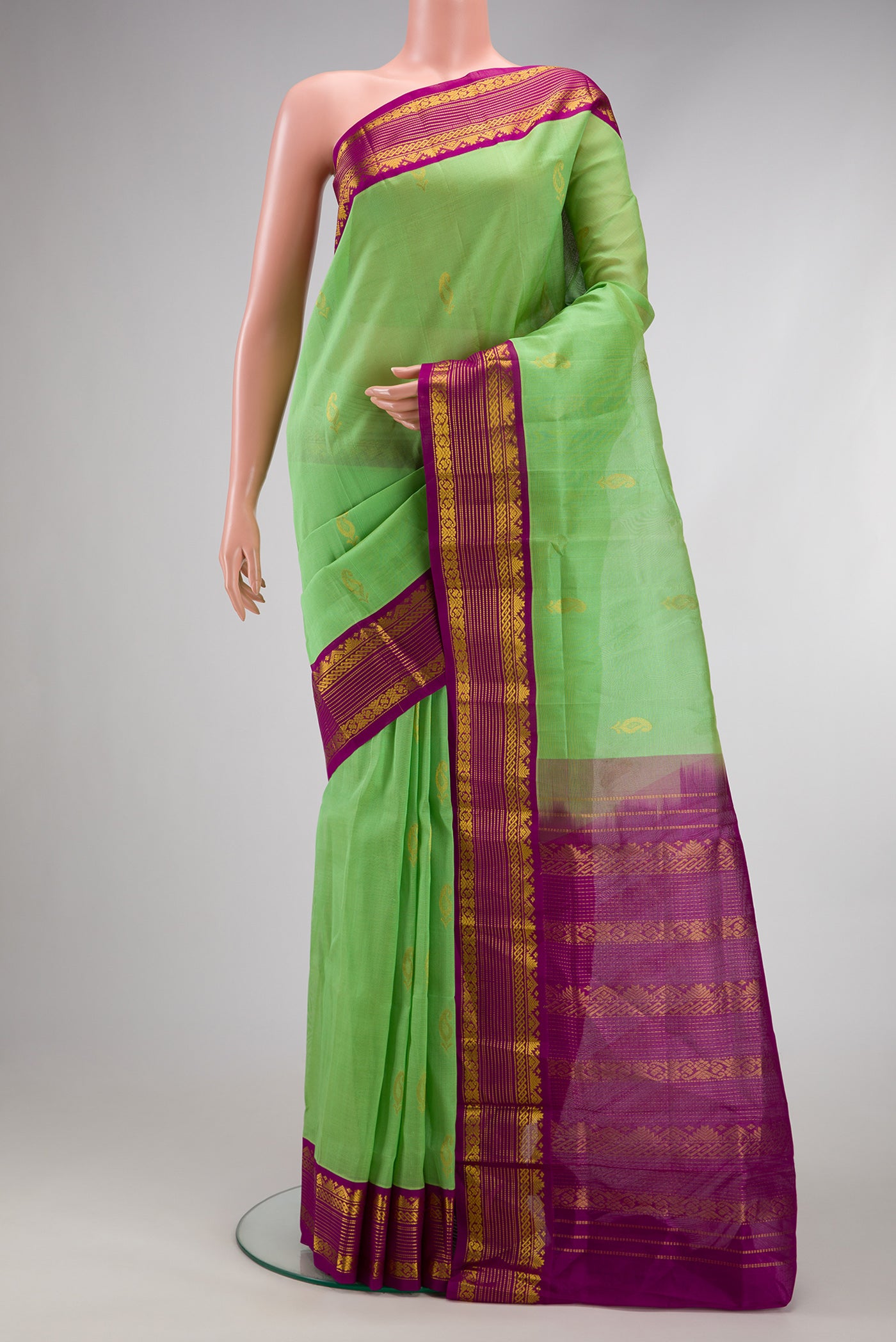 Pista Green Dual Tone Silk Cotton Saree with Zari Butta on the body and Zari Border.  displayed on a mannequin