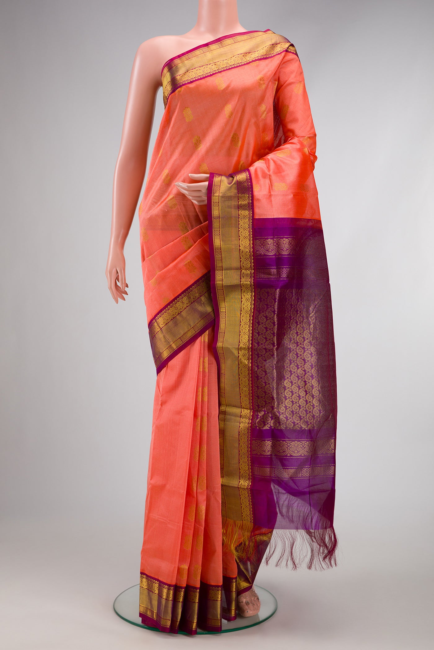 Golden Peach Dual Tone Silk Cotton Saree with Zari Butta on the body and Zari Border.  displayed on a mannequin