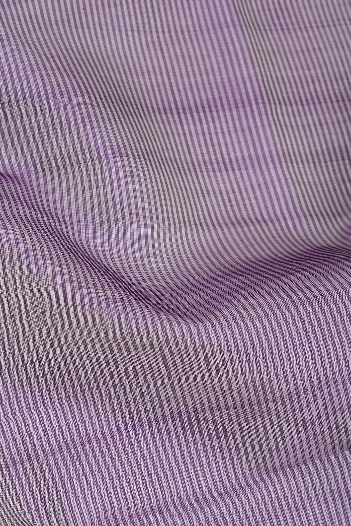 Close up of Purple Dual Tone Silk Cotton Saree with Stripes on the body and Zari Border.  displaying folds