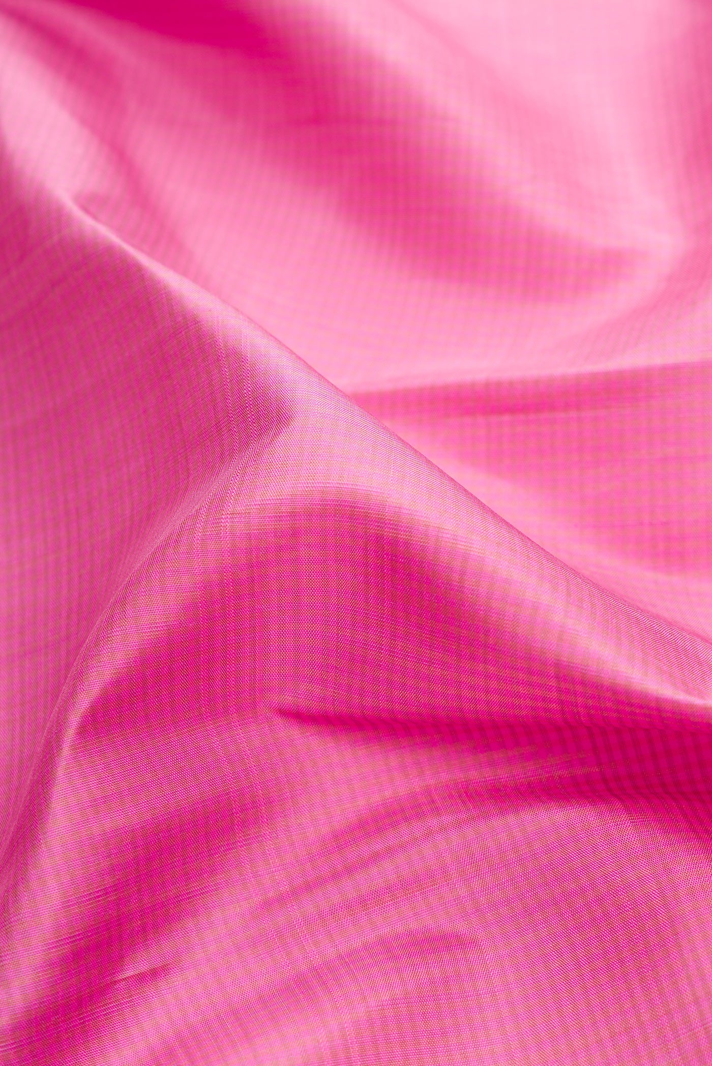 Close up of Pure Silk Pure Zari Pink Dual Tone Kanjivaram Saree with Stripes on the body and Zari Border.  displaying folds