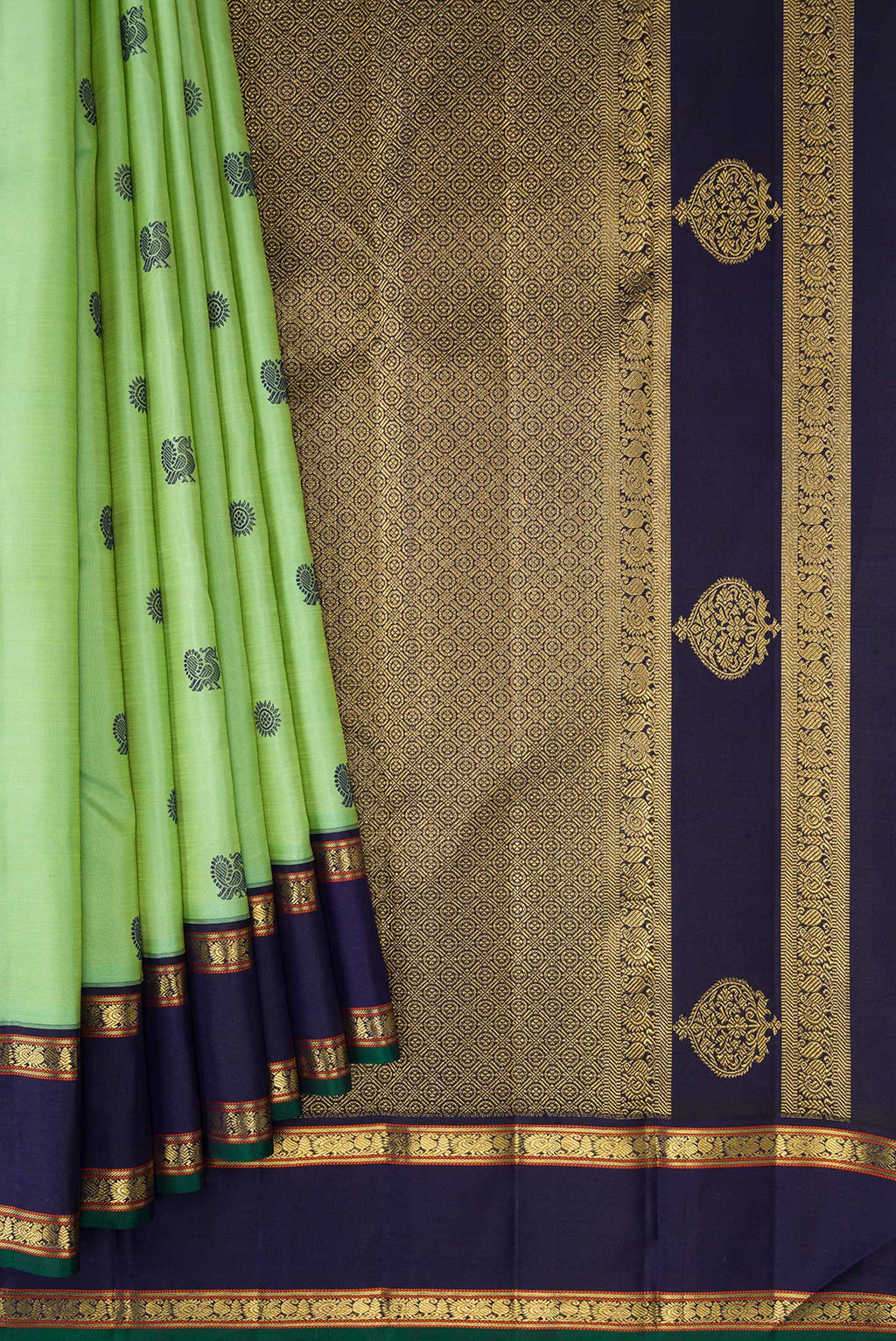 Pleats and pallu of Pure Silk Pure Zari Green Dual Tone Kanchipuram Saree with Thread Butta on the body and Zari And Thread Border. 