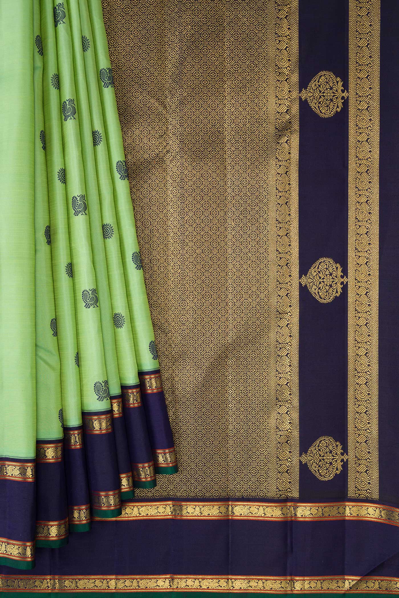 Pleats and pallu of Pure Silk Pure Zari Green Dual Tone Kanchipuram Saree with Thread Butta on the body and Zari And Thread Border. 