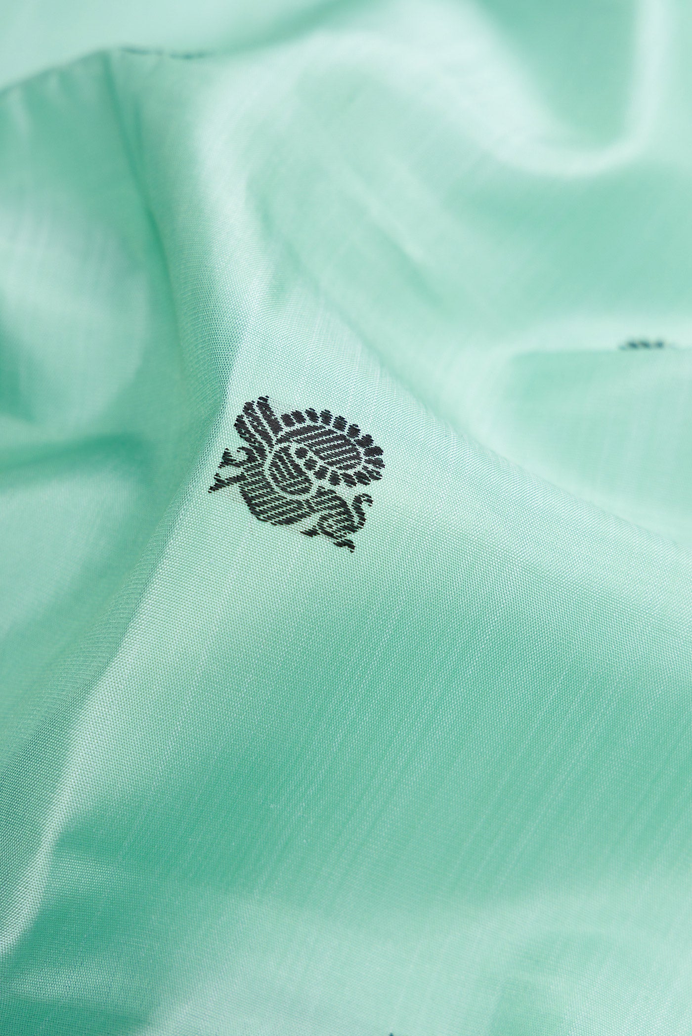 Close up of Pure Silk Pure Zari Light Blue Dual Tone Kanchipuram Saree with Thread Butta on the body and Zari Border.  displaying folds
