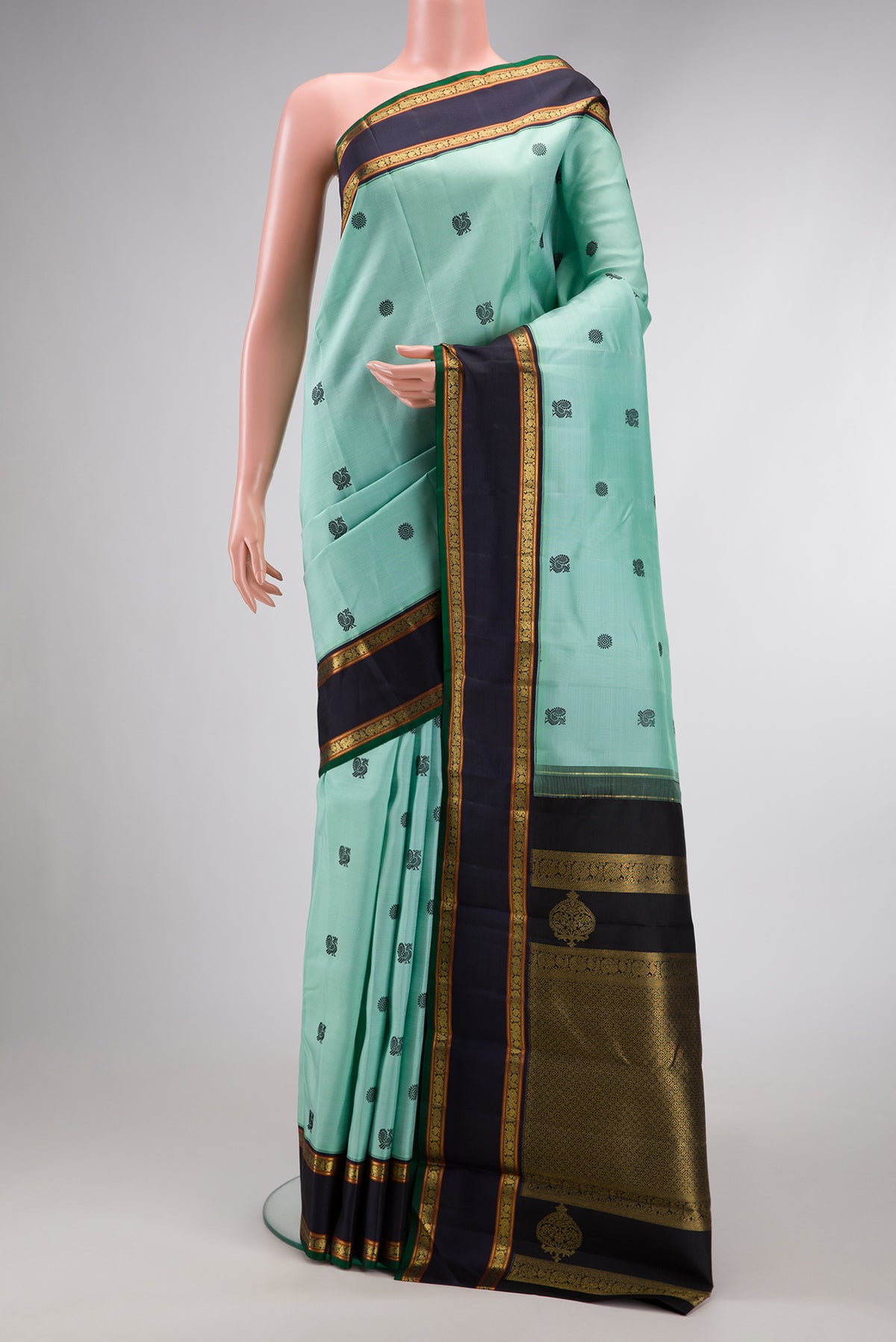 Pure Silk Pure Zari Light Blue Dual Tone Kanchipuram Saree with Thread Butta on the body and Zari Border.  displayed on a mannequin