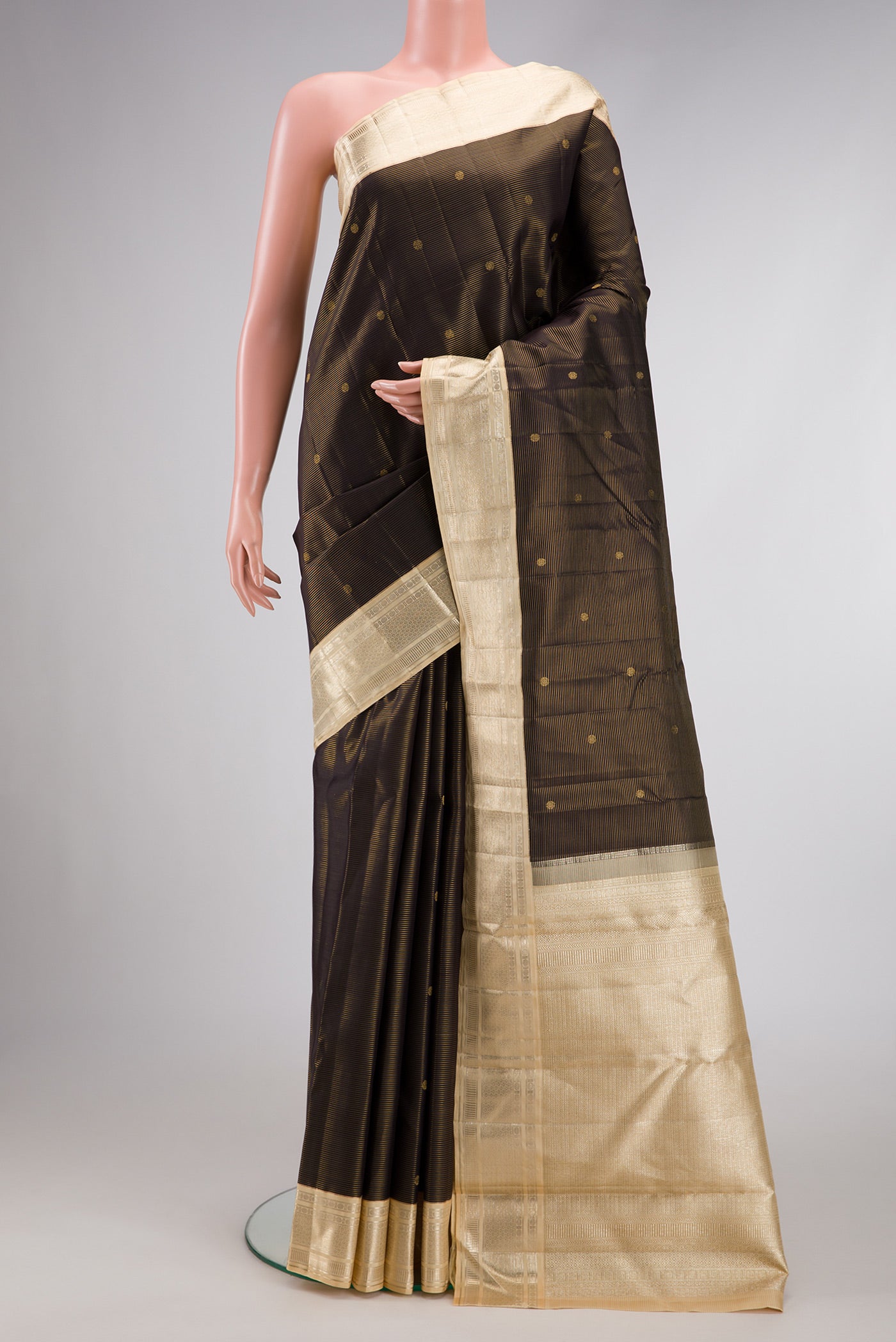 Black Dual Tone Kanchipuram Silk Saree with Stripes on the body and Zari Border.  displayed on a mannequin