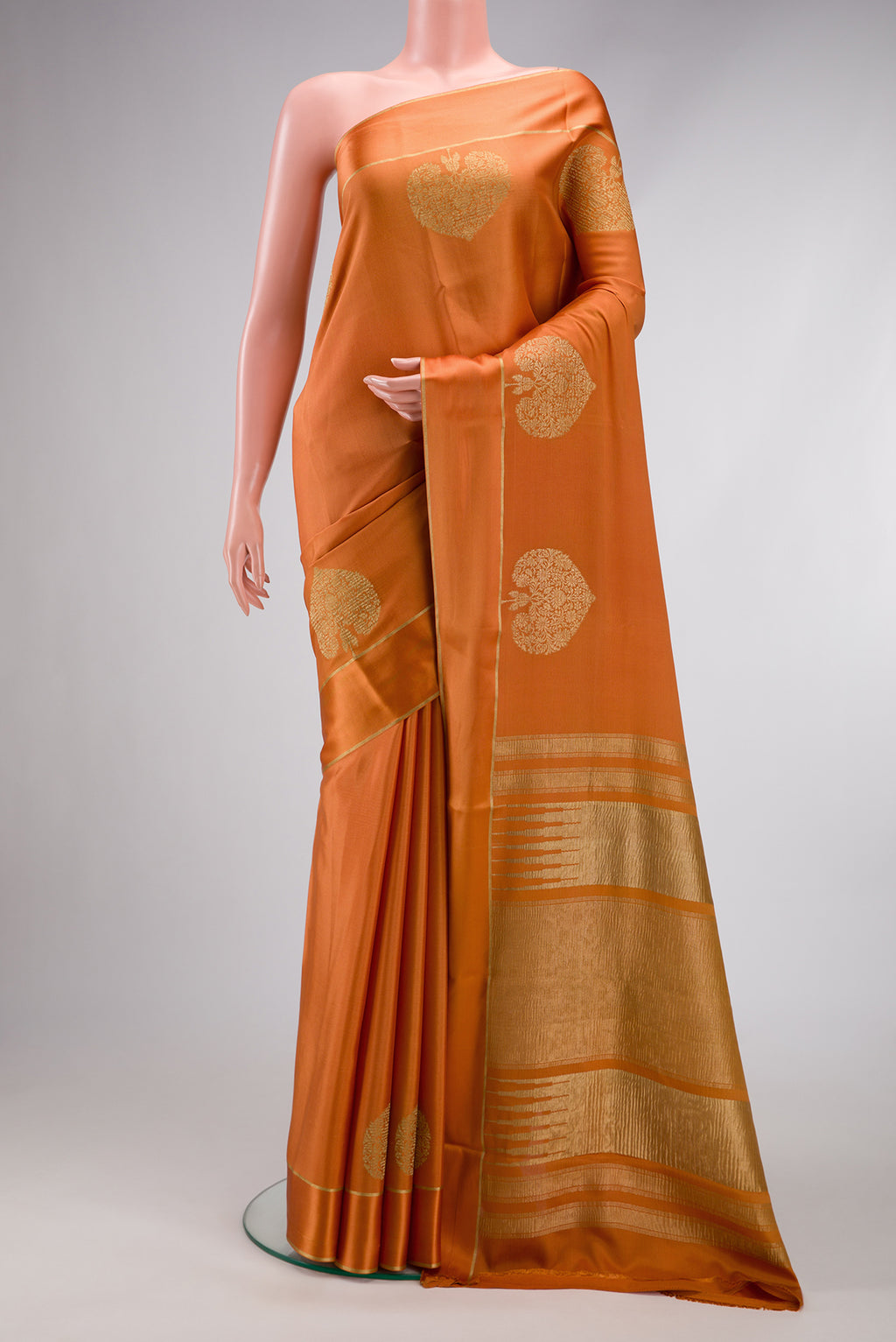 Orange Dual Tone Crepe Saree with Plain Body and Fancy Border.  displayed on a mannequin