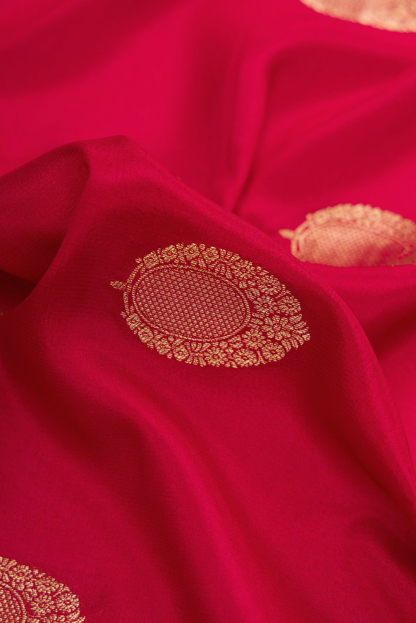 Close up of Red Mysore Crepe Saree with Zari Butta on the body and Zari Border.  displaying folds