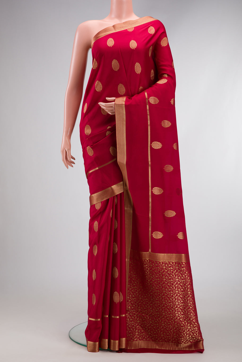 Red Mysore Crepe Saree with Zari Butta on the body and Zari Border.  displayed on a mannequin