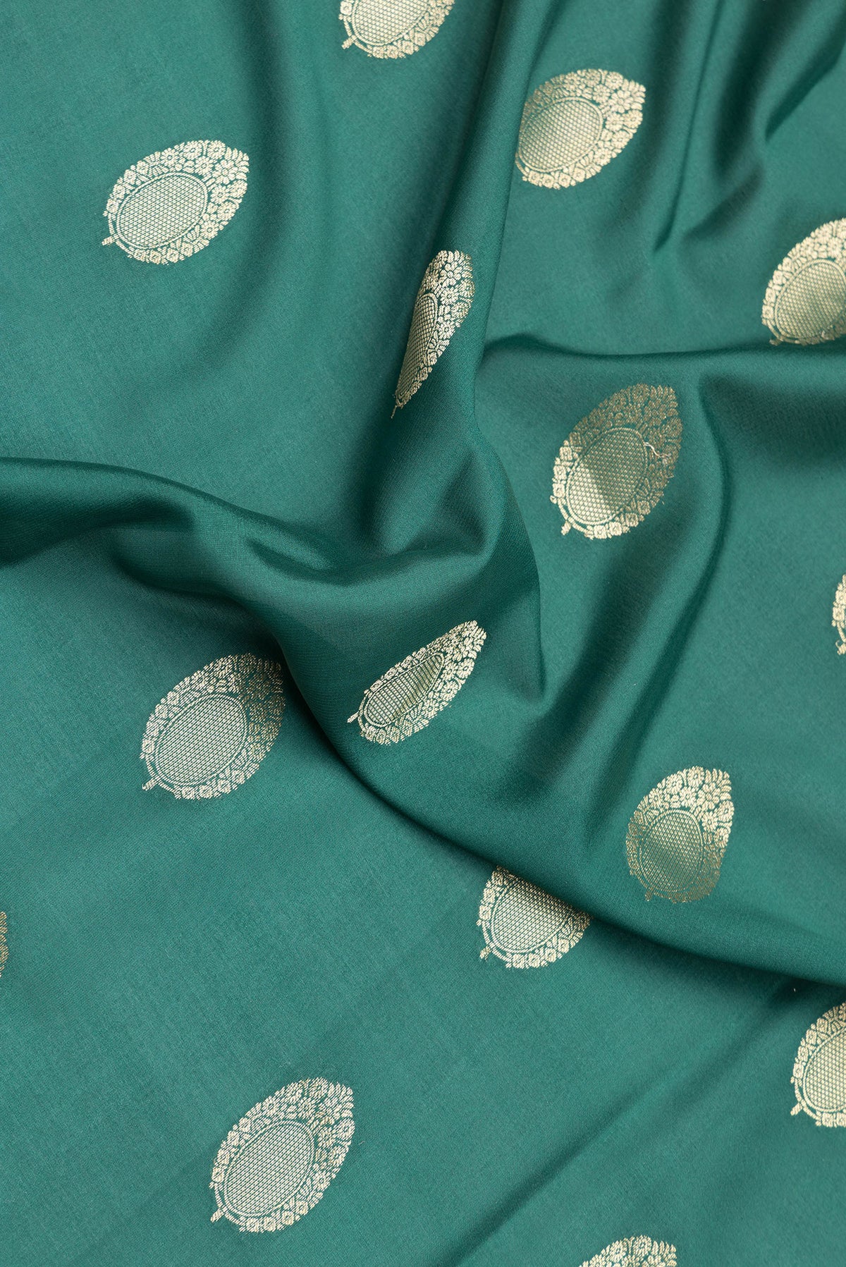 Close up of Bottle Green Dual Tone Mysore Silk Saree with Zari Butta on the body and Zari Border.  displaying folds