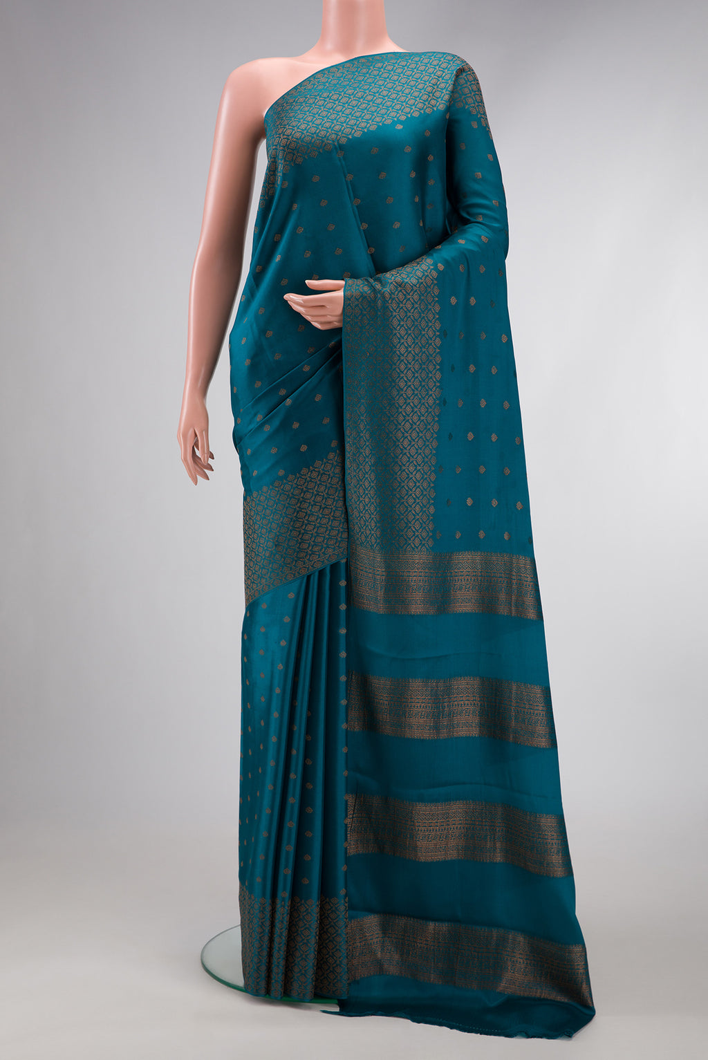 Peacock Blue Dual Tone Mysore Crepe Saree with Zari Butta on the body and Fancy Border.  displayed on a mannequin
