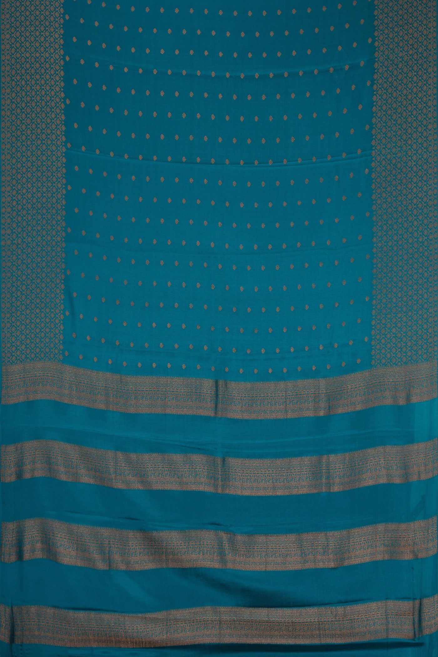 Flat view of Peacock Blue Dual Tone Mysore Crepe Saree with Zari Butta on the body and Fancy Border. 