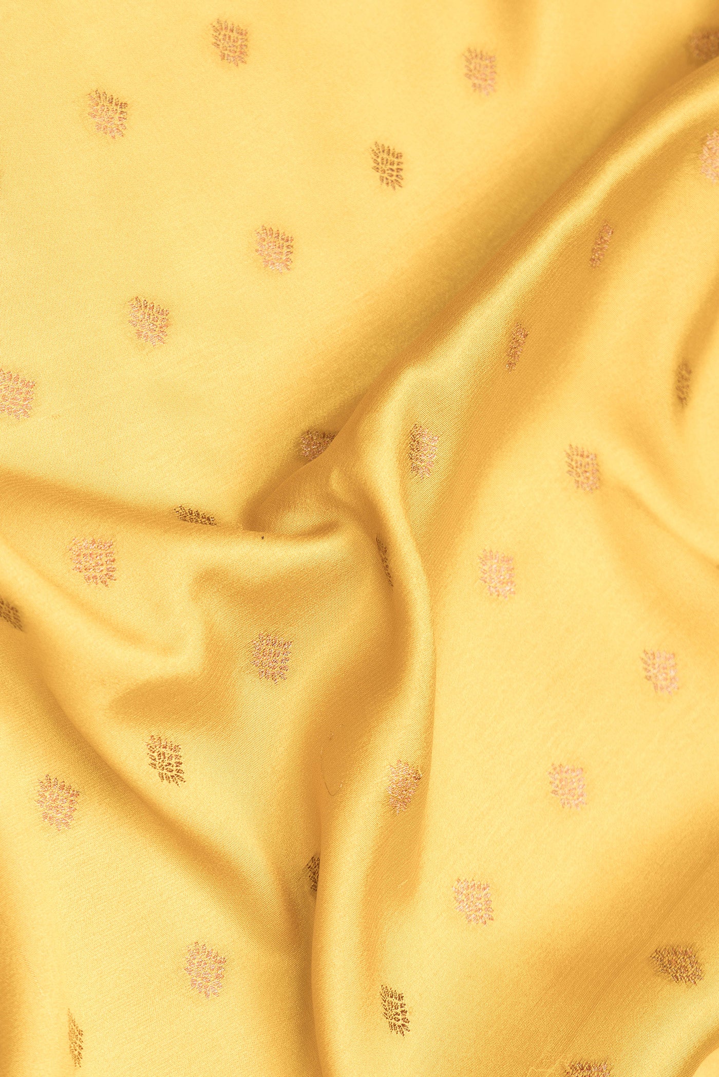 Close up of Mustard Dual Tone Mysore Crepe Saree with Zari Butta on the body and Zari Border.  displaying folds