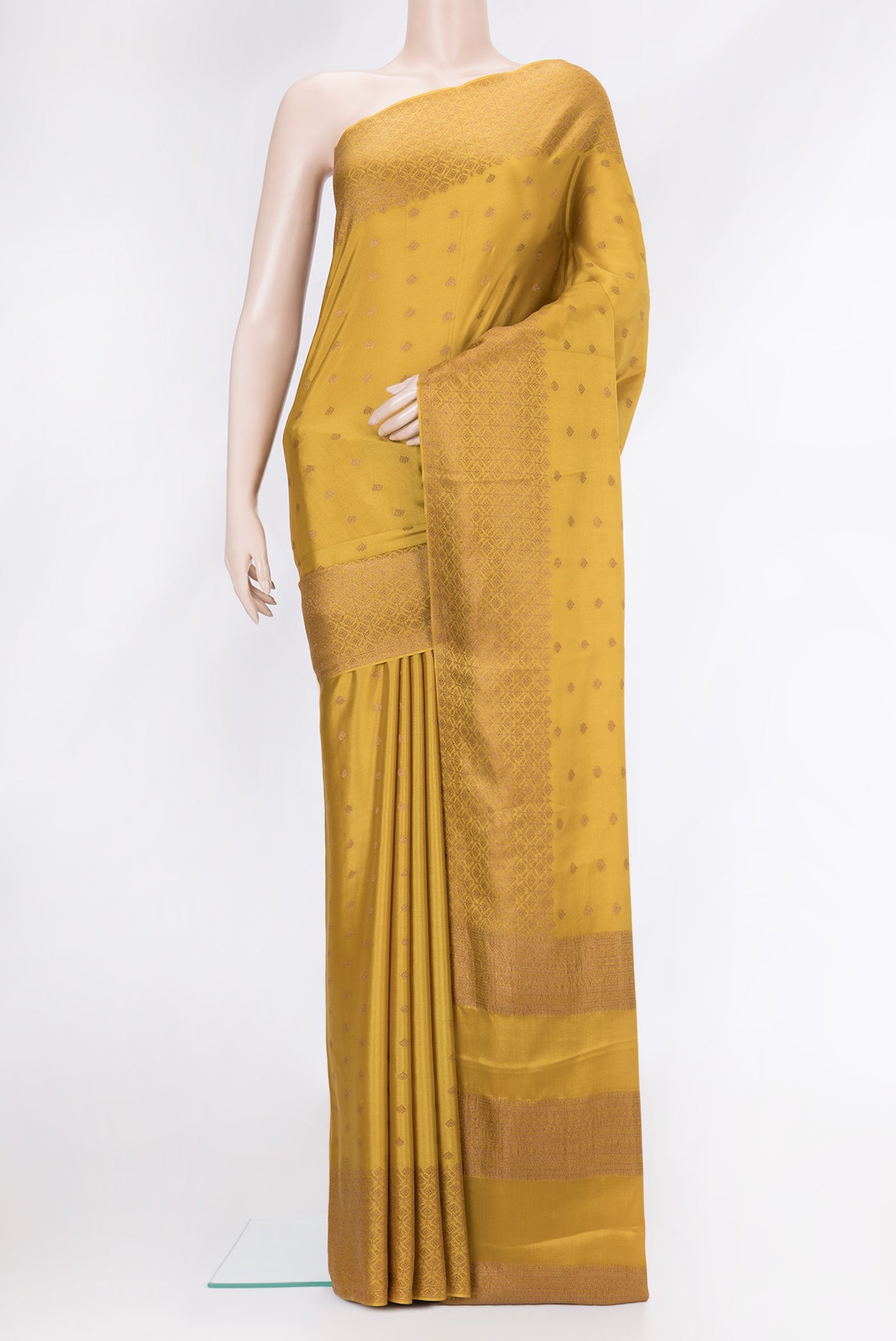 Mustard Dual Tone Mysore Crepe Saree with Zari Butta on the body and Zari Border.  displayed on a mannequin