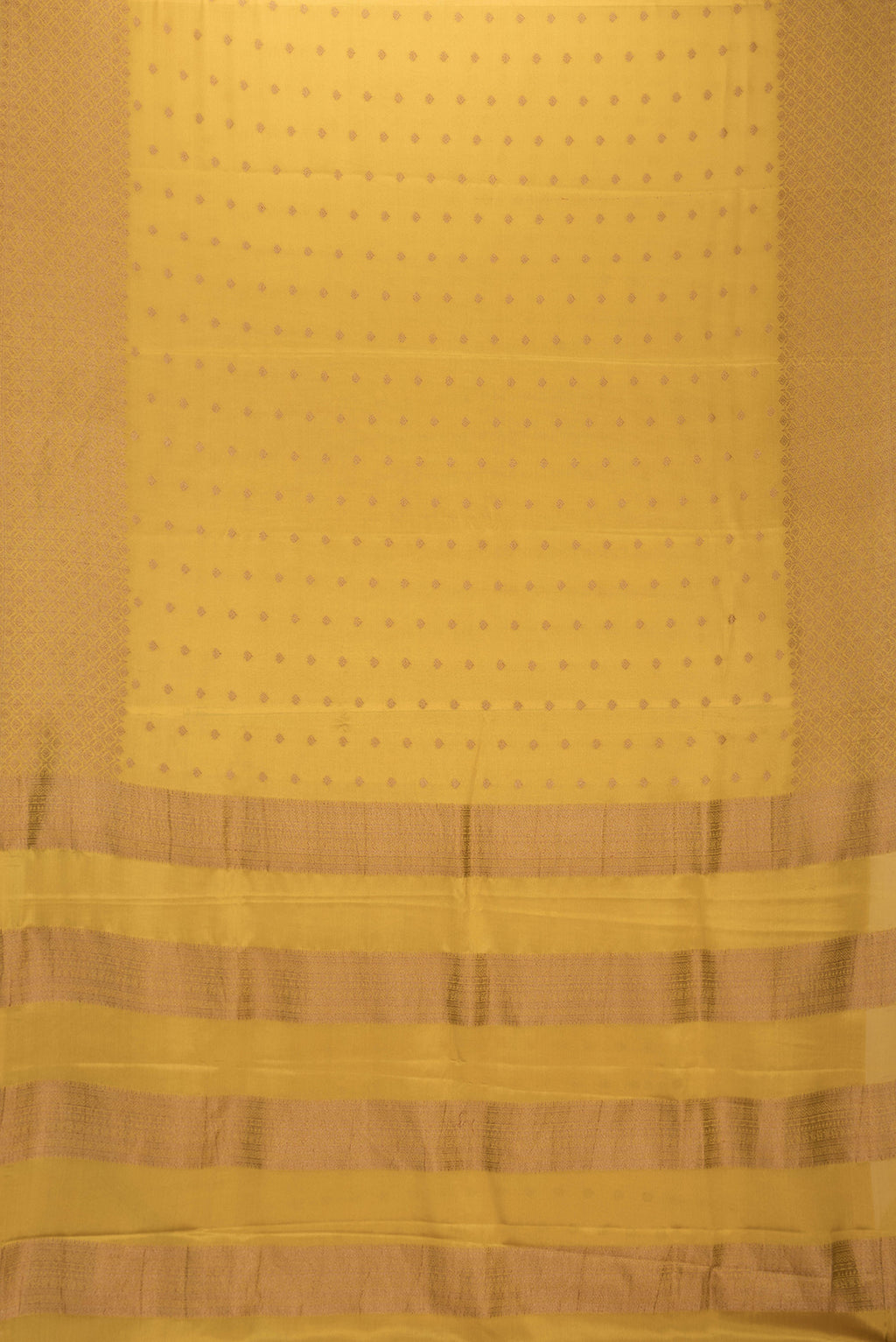 Flat view of Mustard Dual Tone Mysore Crepe Saree with Zari Butta on the body and Zari Border. 