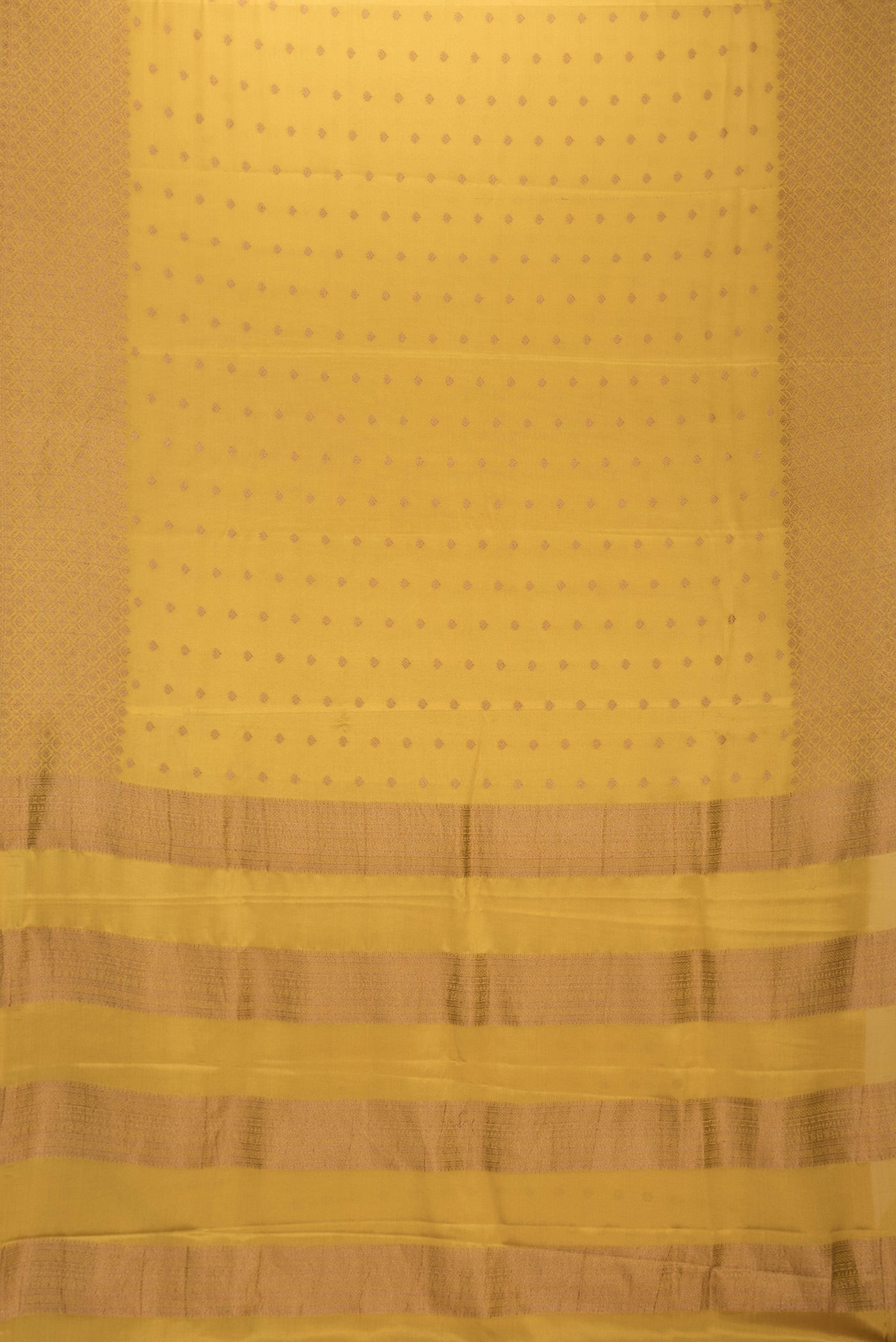 Flat view of Mustard Dual Tone Mysore Crepe Saree with Zari Butta on the body and Zari Border. 