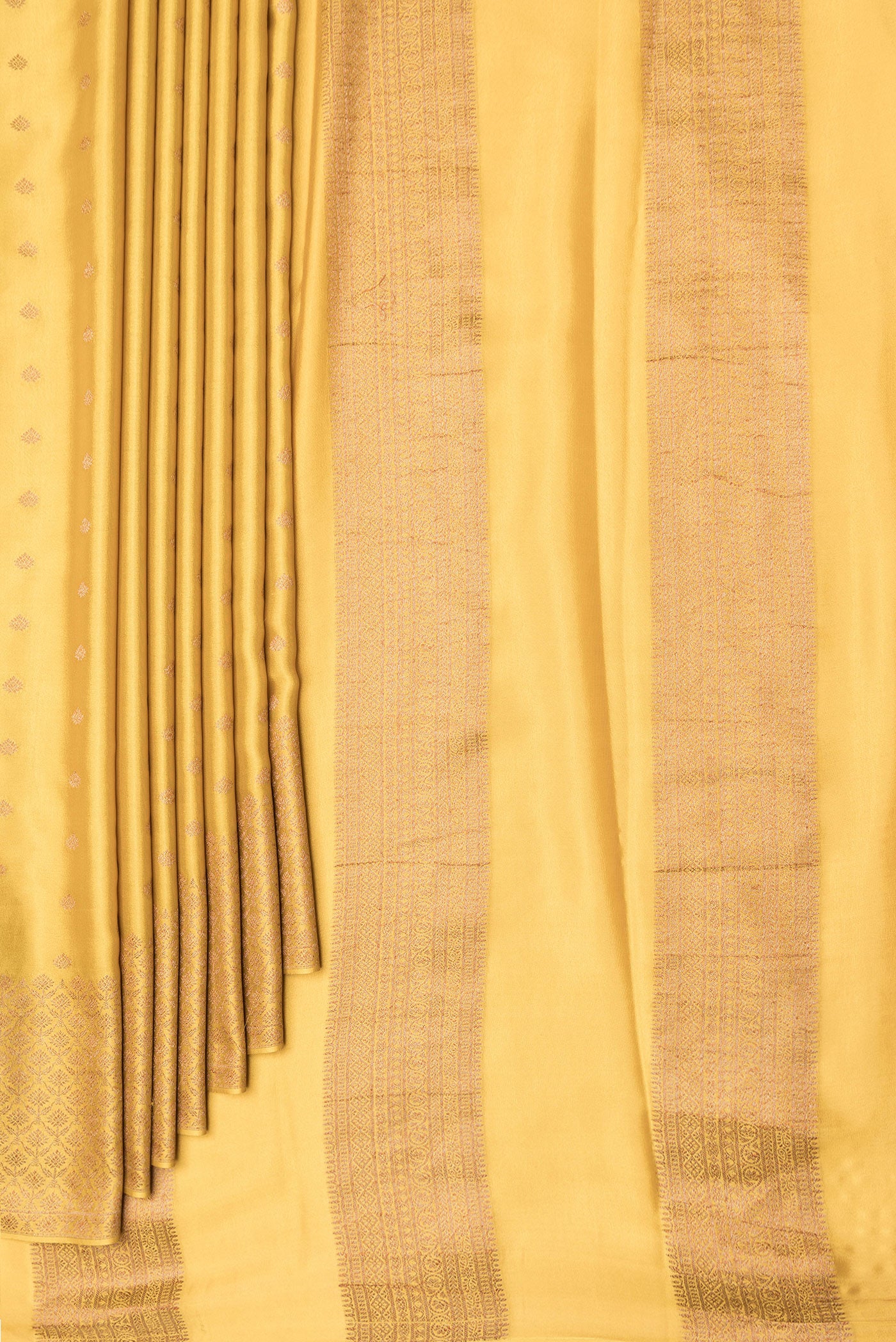 Pleats and pallu of Mustard Dual Tone Mysore Crepe Saree with Zari Butta on the body and Zari Border. 