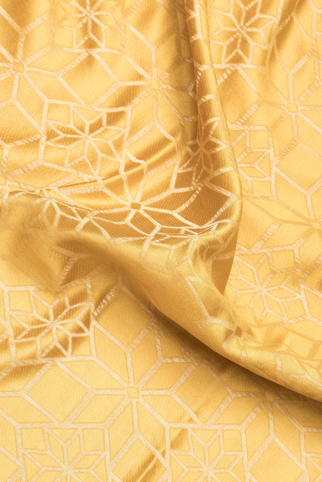 Close up of Gold Dual Tone Mysore Crepe Saree with Zari Brocade on the body and Zari Border.  displaying folds