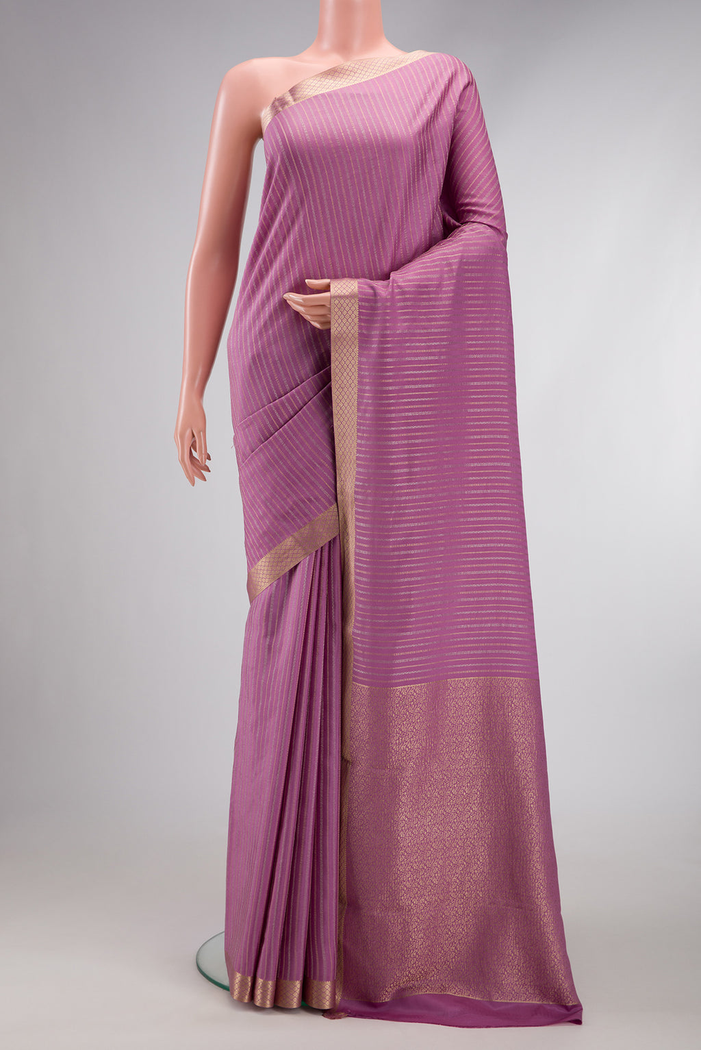 Lavender Dual Tone Mysore Crepe Saree with Stripes on the body and Zari Border.  displayed on a mannequin