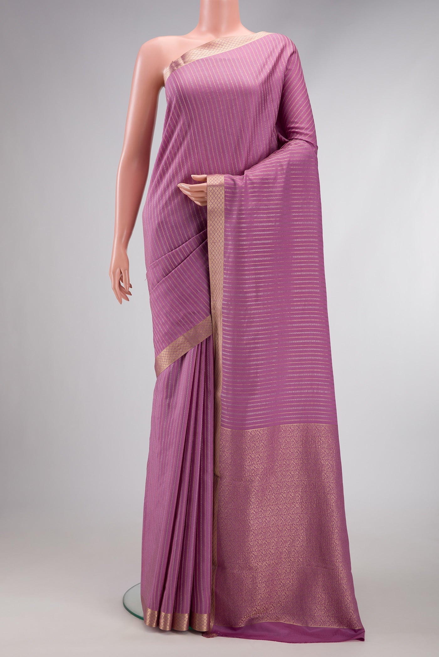 Lavender Dual Tone Mysore Crepe Saree with Stripes on the body and Zari Border.  displayed on a mannequin