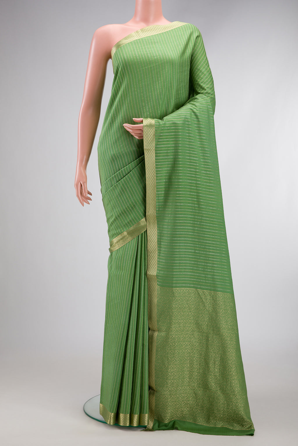 Pista Green Mysore Crepe Saree with Stripes on the body and Zari Border.  displayed on a mannequin