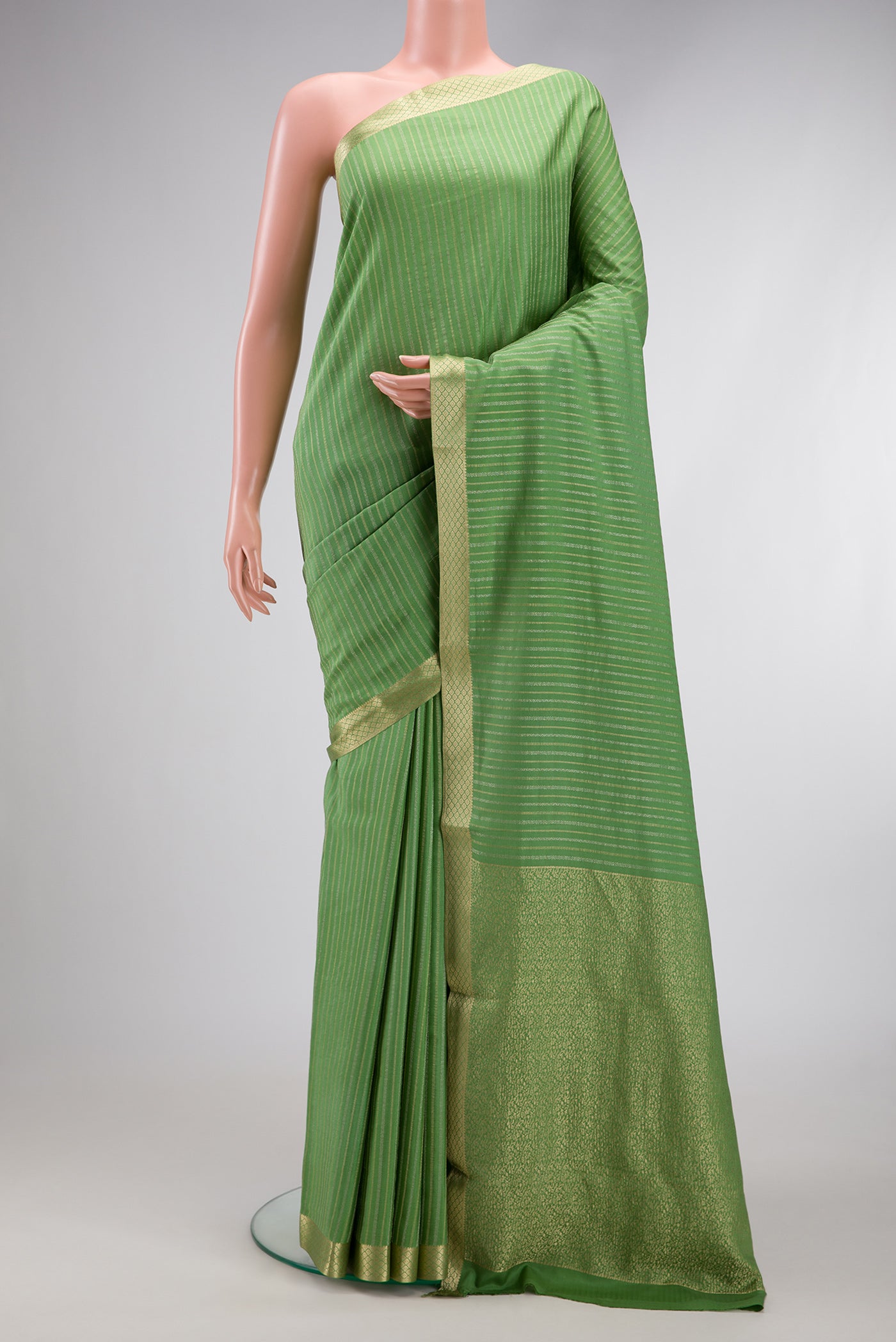 Pista Green Mysore Crepe Saree with Stripes on the body and Zari Border.  displayed on a mannequin