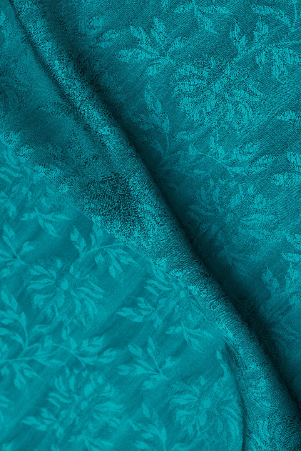 Close up of Peacock Blue Dual Tone Mysore Crepe Saree with Jacquard design on the body and Zari Border.  displaying folds