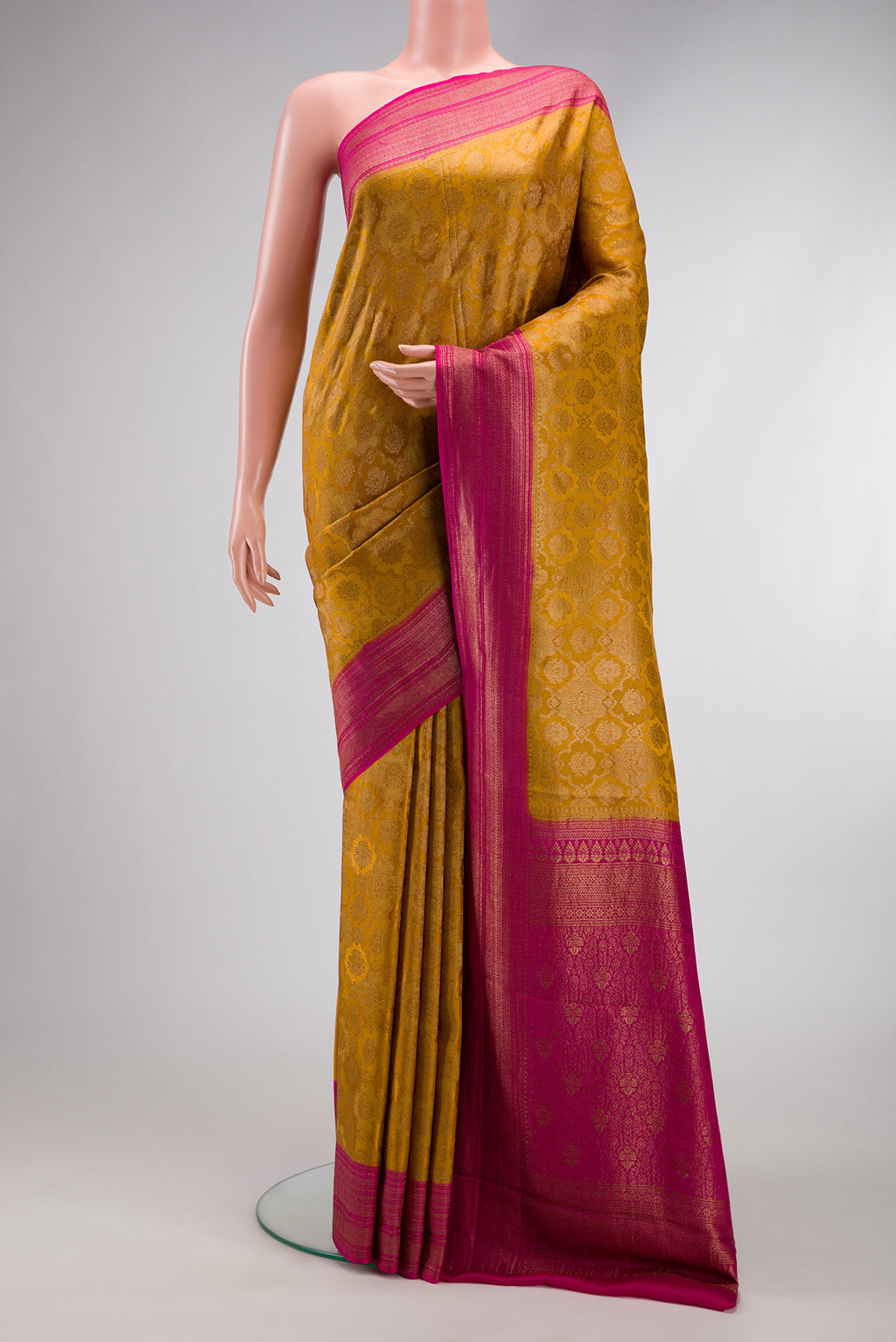 Mustard Mysore Crepe Saree with Zari Brocade on the body and Zari Border.  displayed on a mannequin