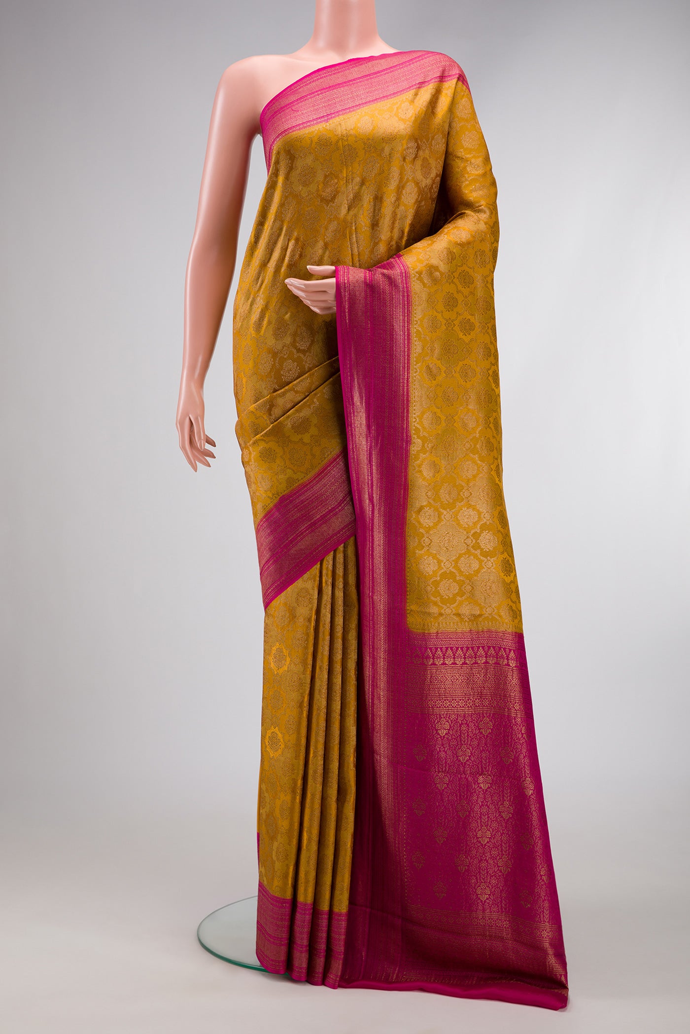 Mustard Mysore Crepe Saree with Zari Brocade on the body and Zari Border.  displayed on a mannequin
