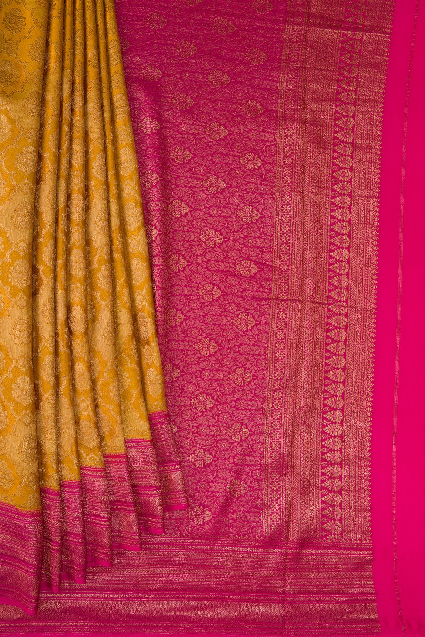 Pleats and pallu of Mustard Mysore Crepe Saree with Zari Brocade on the body and Zari Border. 