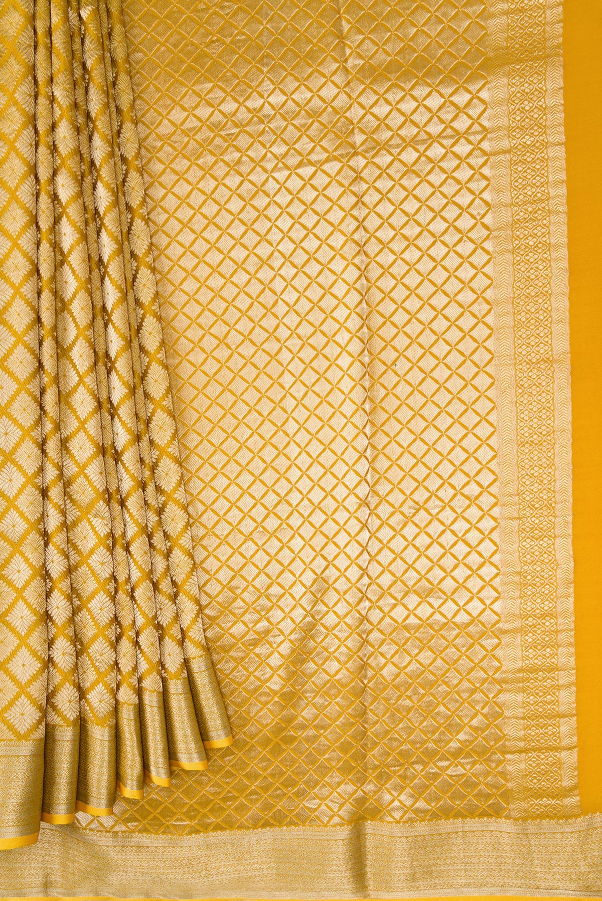 Pleats and pallu of Mustard Dual Tone Mysore Crepe Saree with Zari Brocade on the body and Zari Border. 