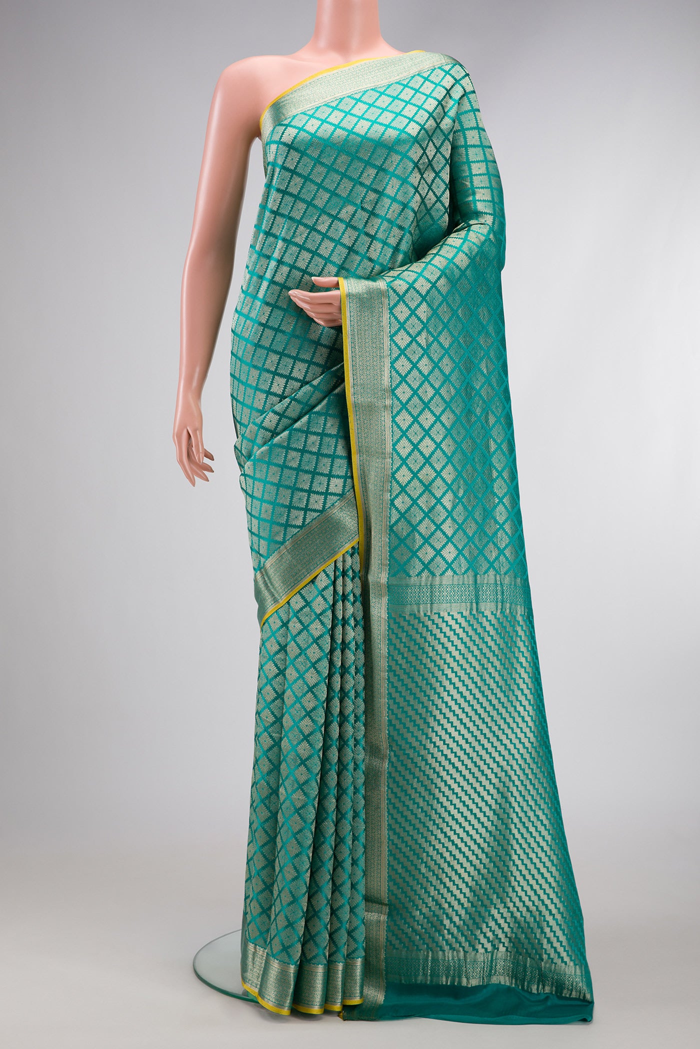 Sky Blue Mysore Crepe Saree with Zari Brocade on the body and Zari Border.  displayed on a mannequin