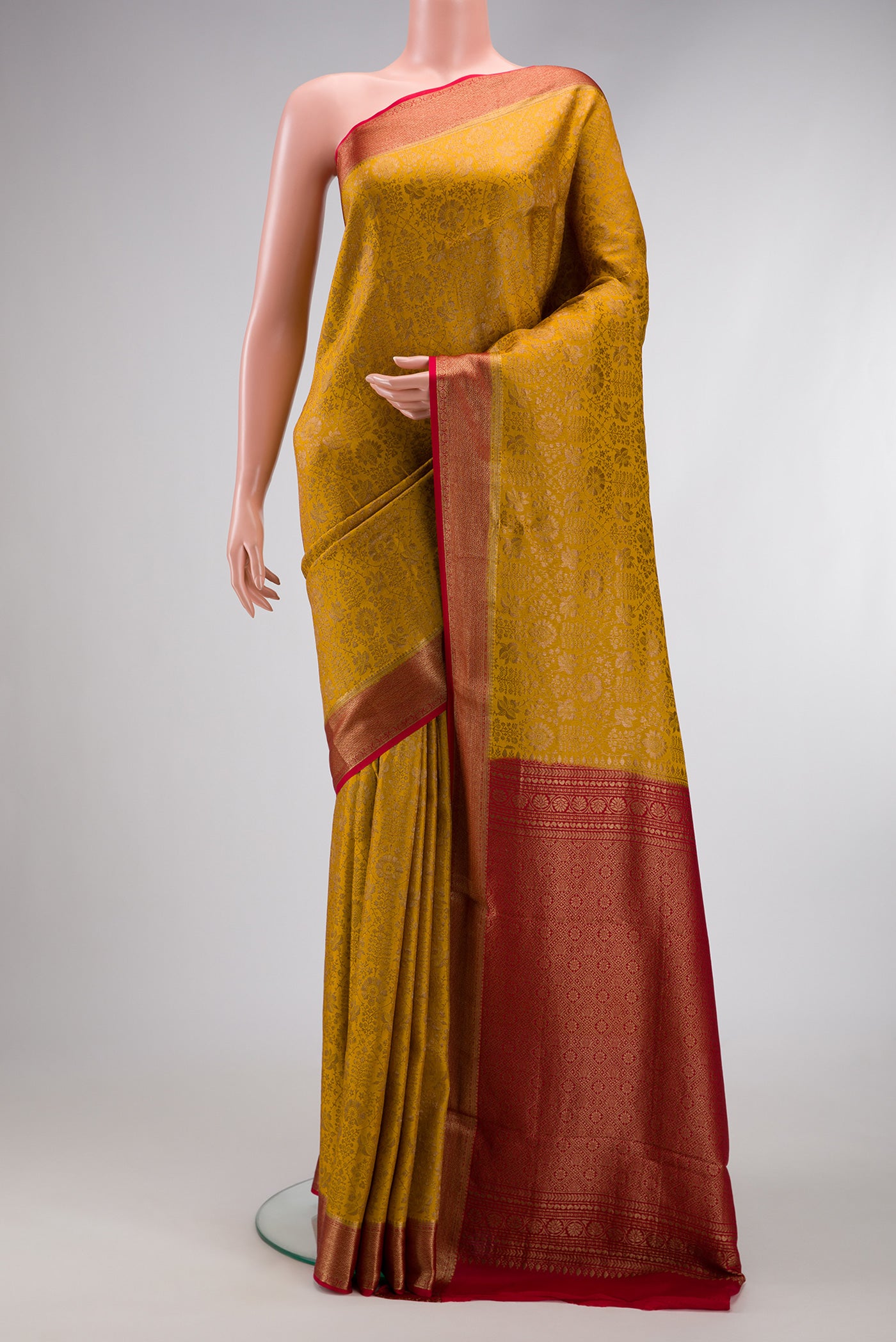 Mustard Mysore Crepe Saree with Zari Brocade on the body and Zari Border.  displayed on a mannequin