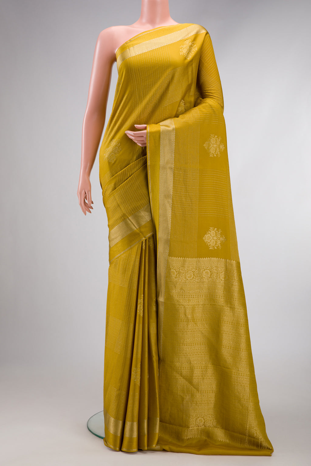 Mehandi Green Dual Tone Mysore Crepe Saree with Zari Butta on the body and Zari Border.  displayed on a mannequin