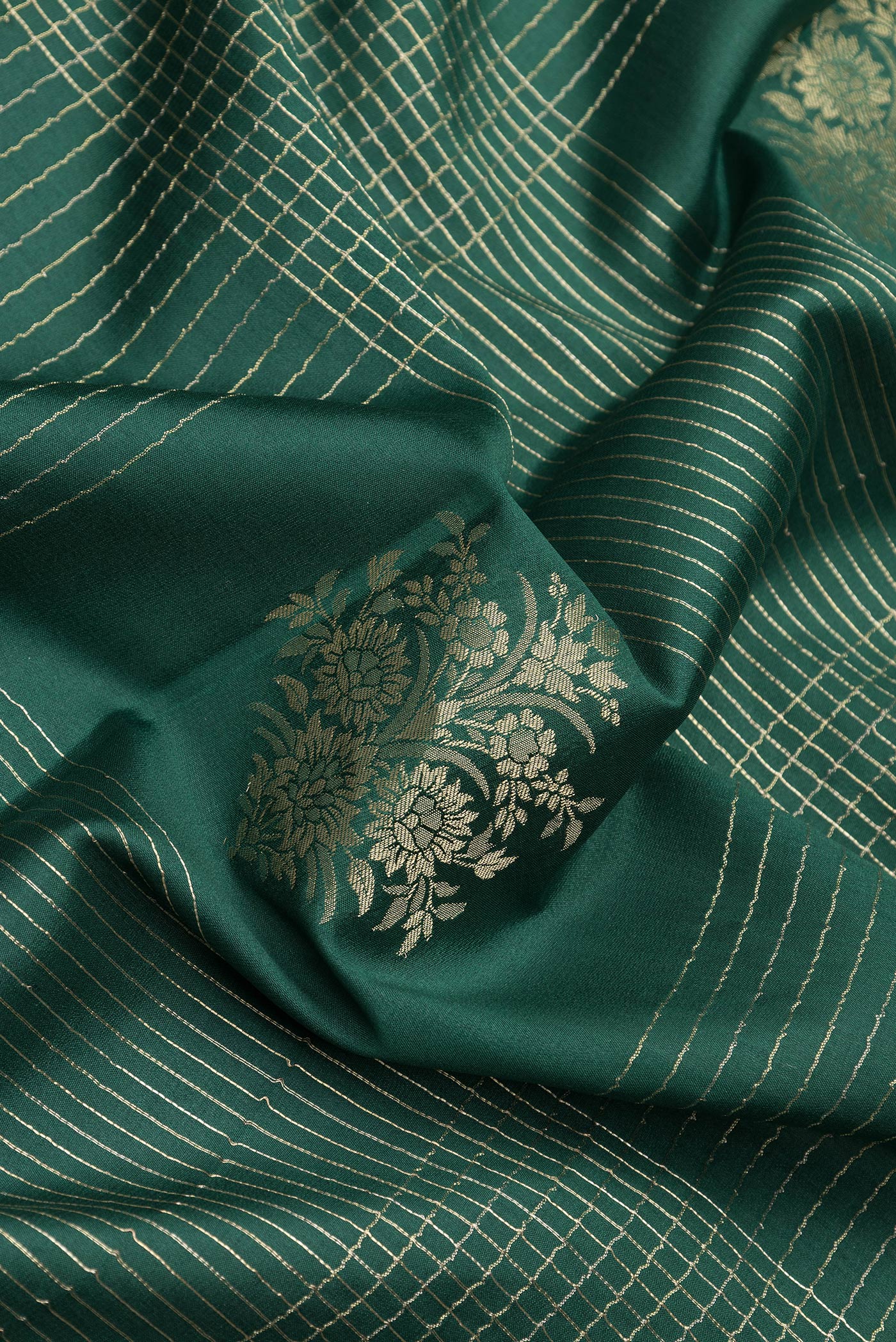 Close up of Bottle Green Dual Tone Banarasi Georgette Saree with Checked design on the body and Zari Border.  displaying folds