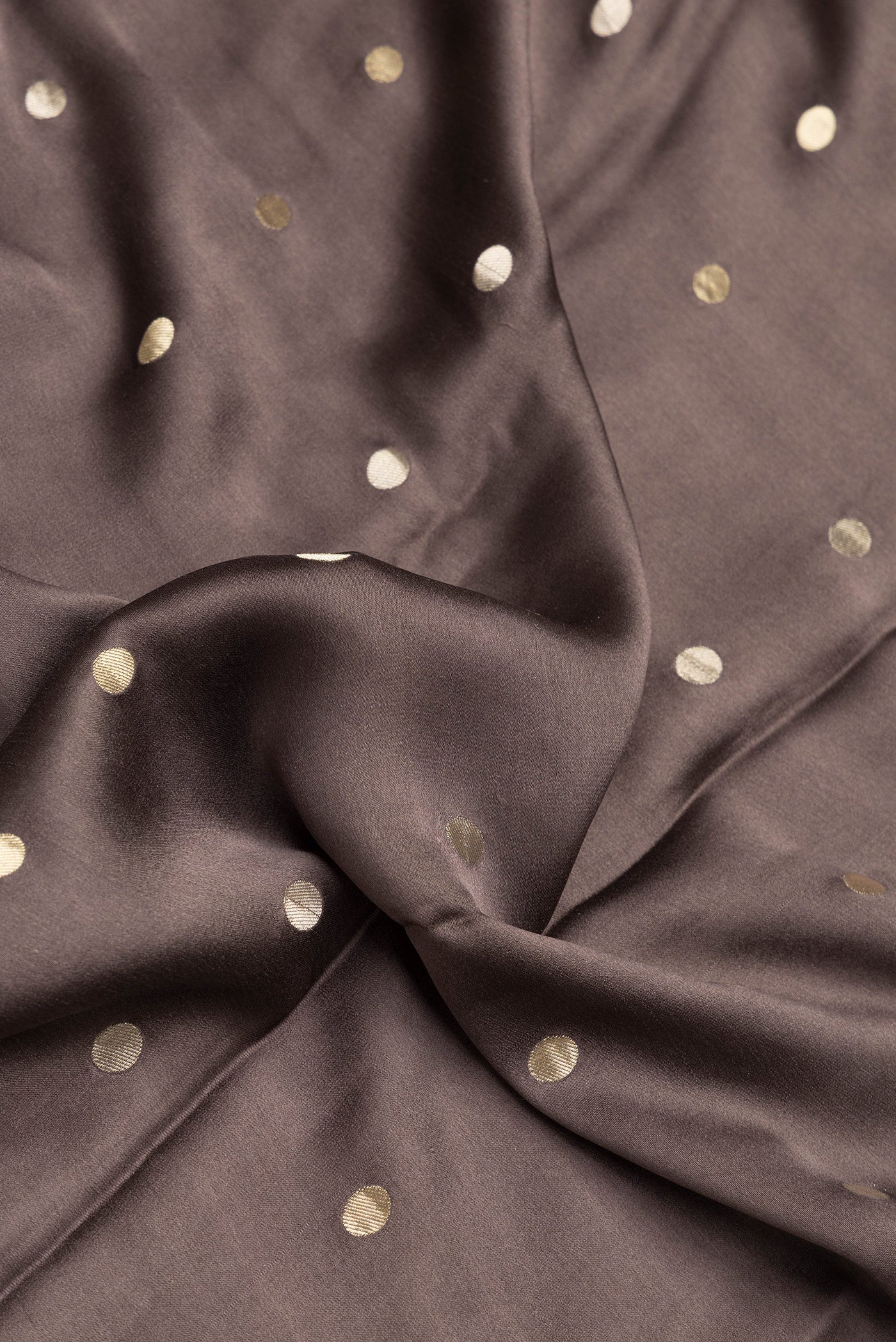Close up of Brown Dual Tone Mysore Silk Saree with Zari Butta on the body and Zari Border.  displaying folds