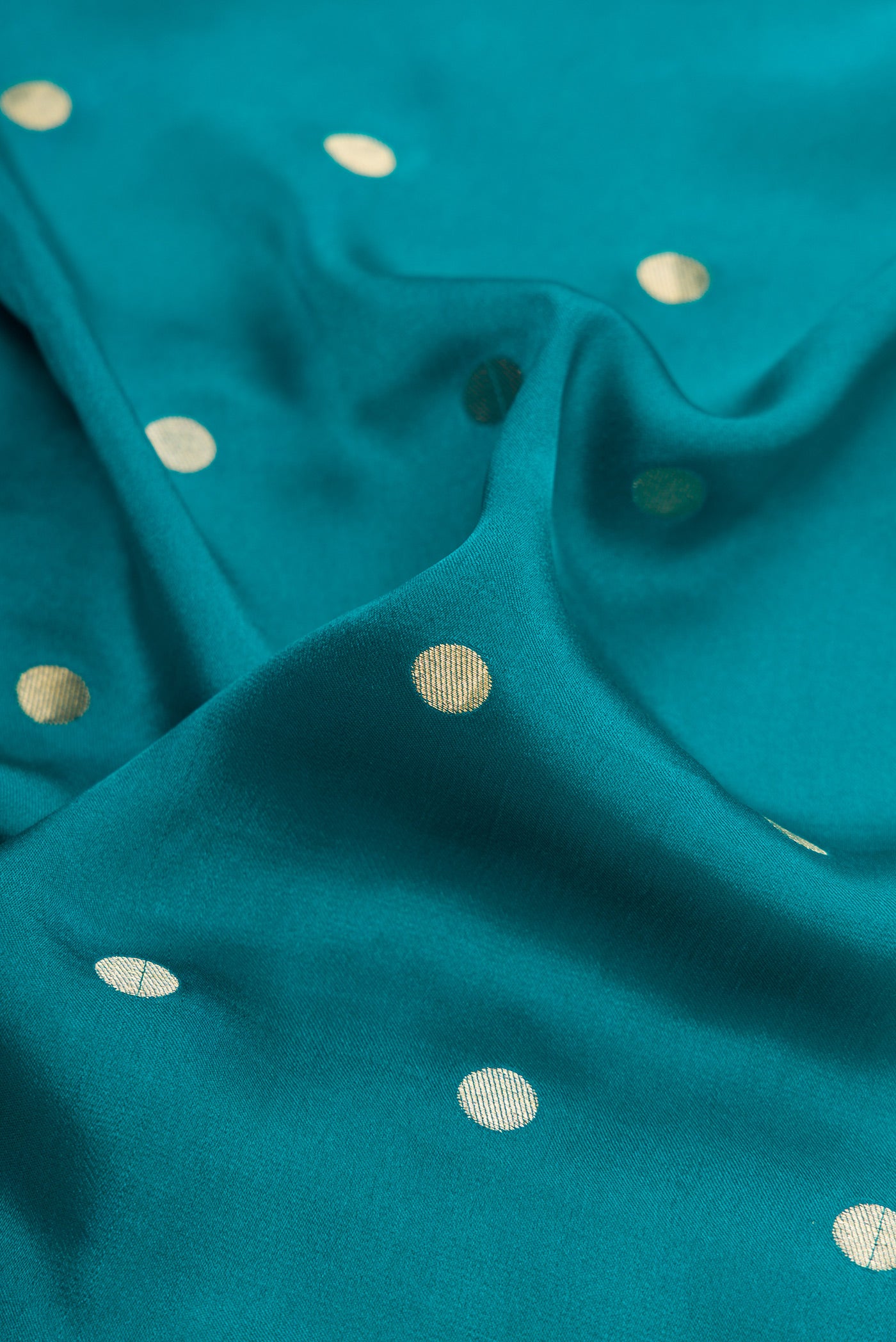 Close up of Peacock Blue Mysore Chiffon Saree with Zari Butta on the body and Zari Border.  displaying folds