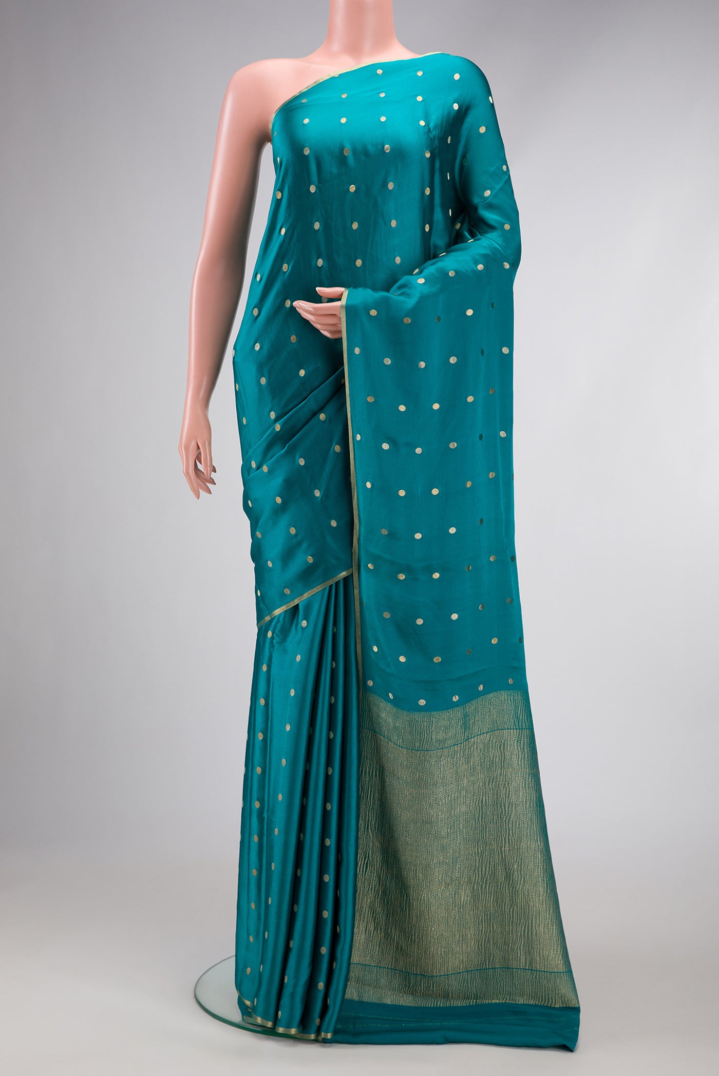 Peacock Blue Mysore Chiffon Saree with Zari Butta on the body and Zari Border.  displayed on a mannequin