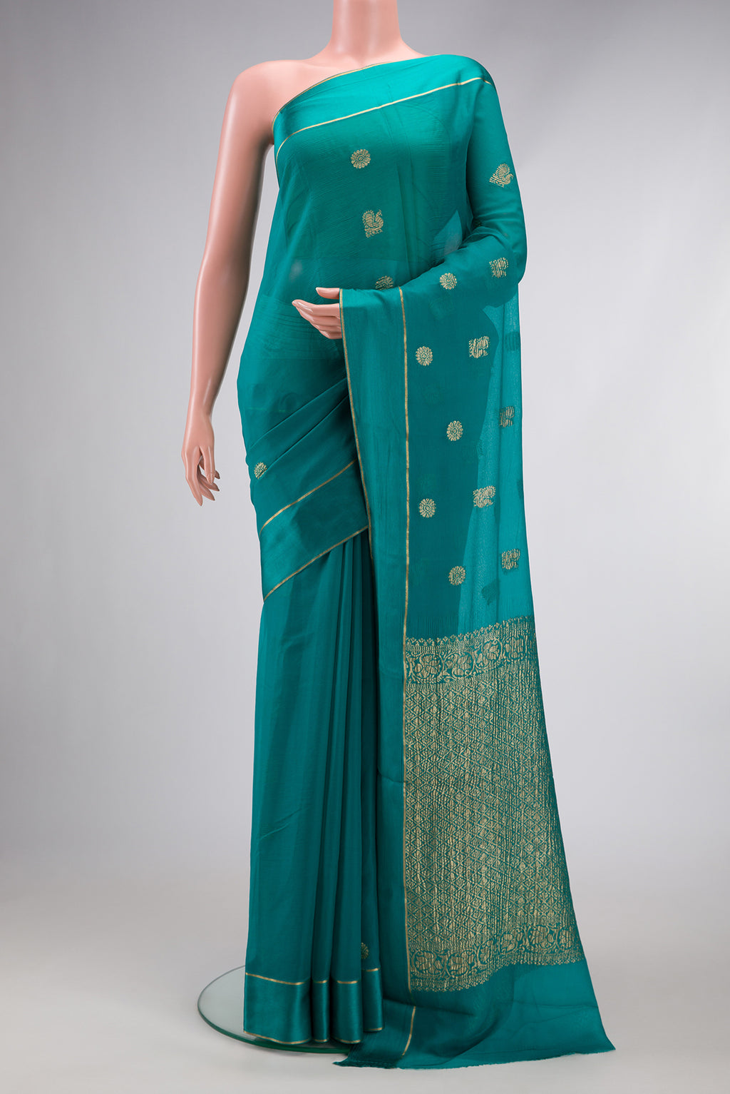 Peacock Blue Mysore Georgette Saree with Zari Butta on the body and Zari Border.  displayed on a mannequin
