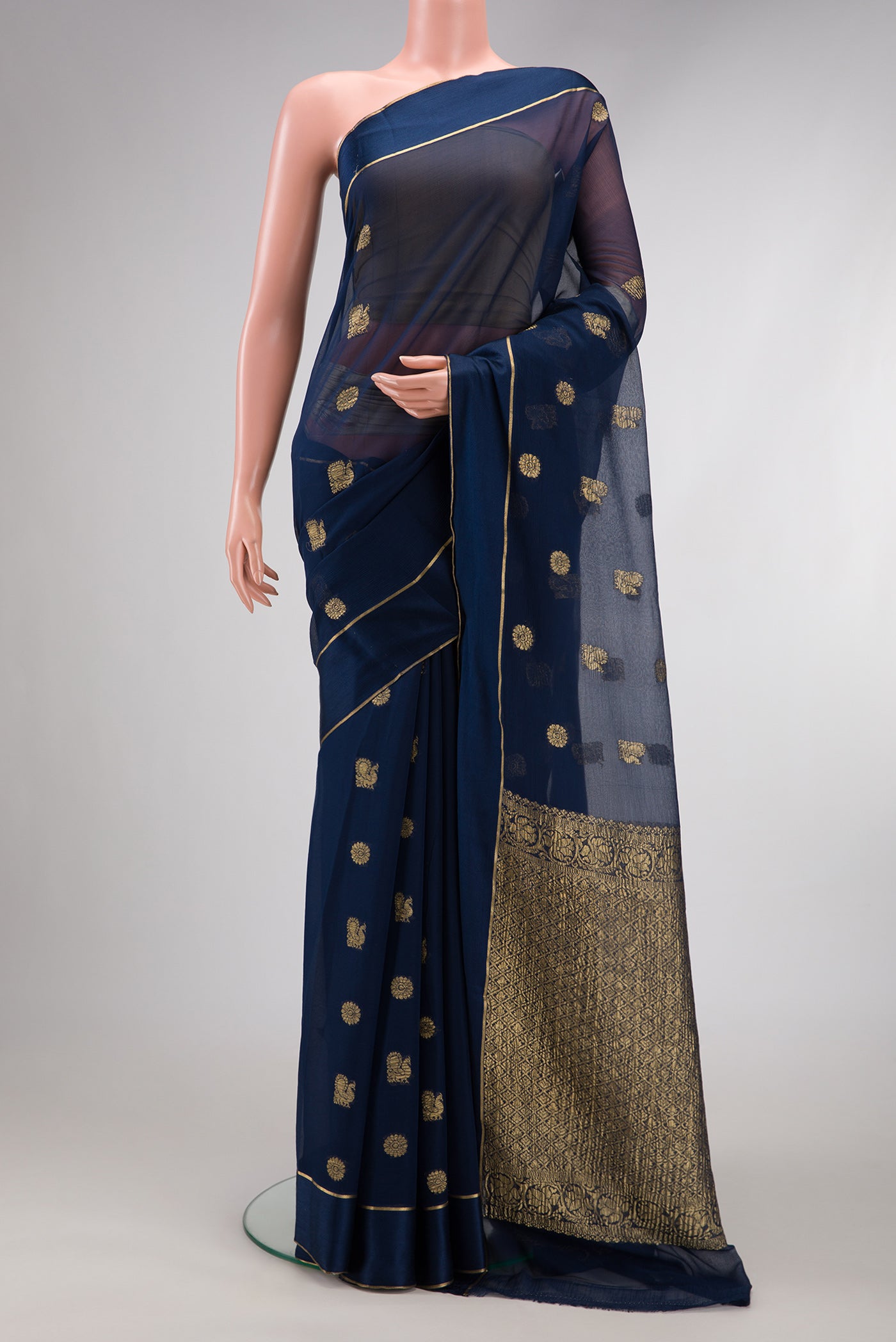 Navy Blue Mysore Georgette Saree with Zari Butta on the body and Zari Border.  displayed on a mannequin