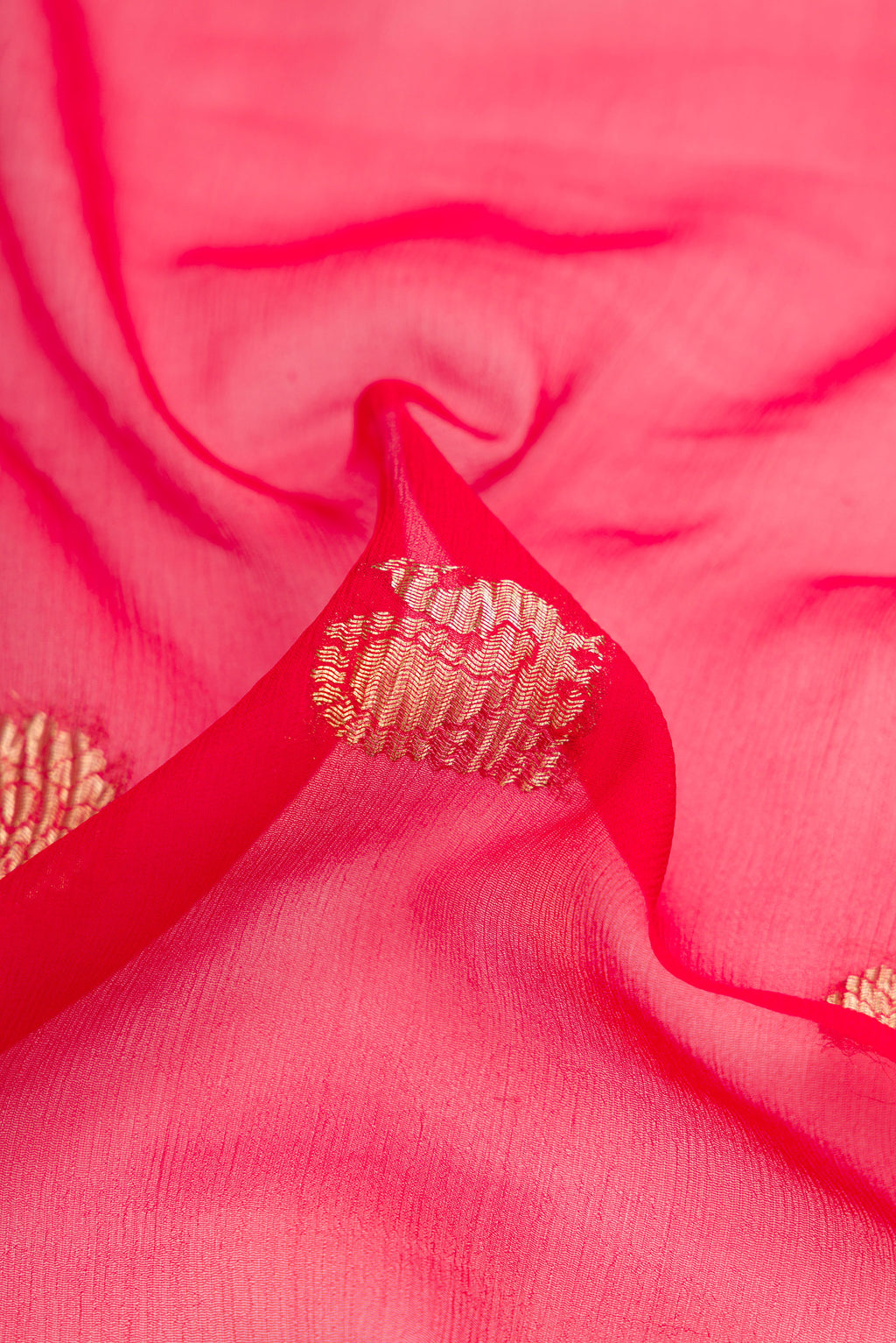 Close up of Red Dual Tone Mysore Georgette Saree with Zari Butta on the body and Plain Border.  displaying folds
