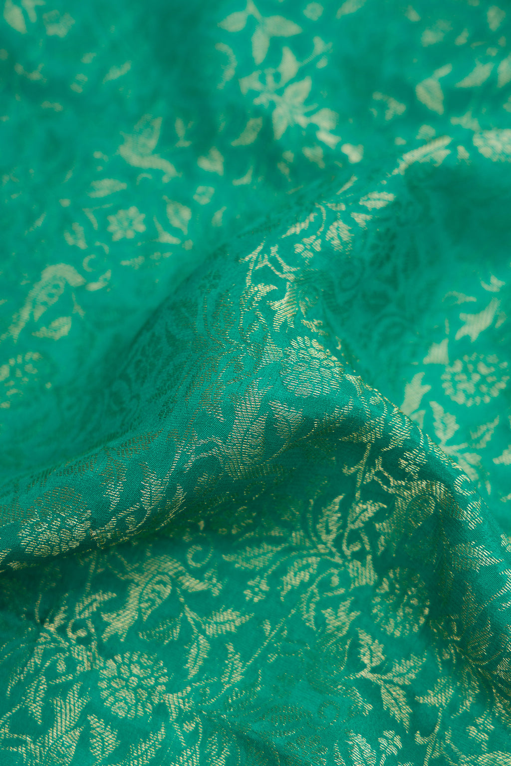 Close up of Beige and Off White Dual Tone Georgette Saree with Zari Brocade on the body and Zari Border.  displaying folds