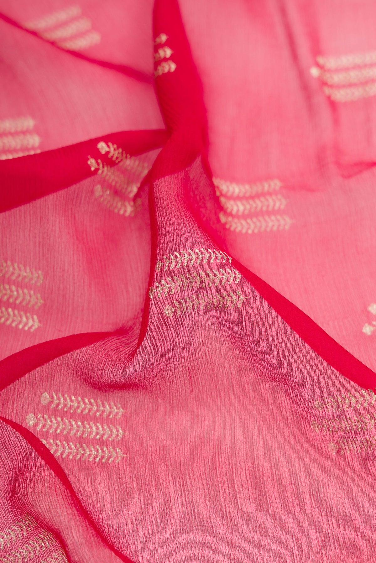 Close up of Red Mysore Chiffon Saree with Printed design on the body and Zari Border.  displaying folds