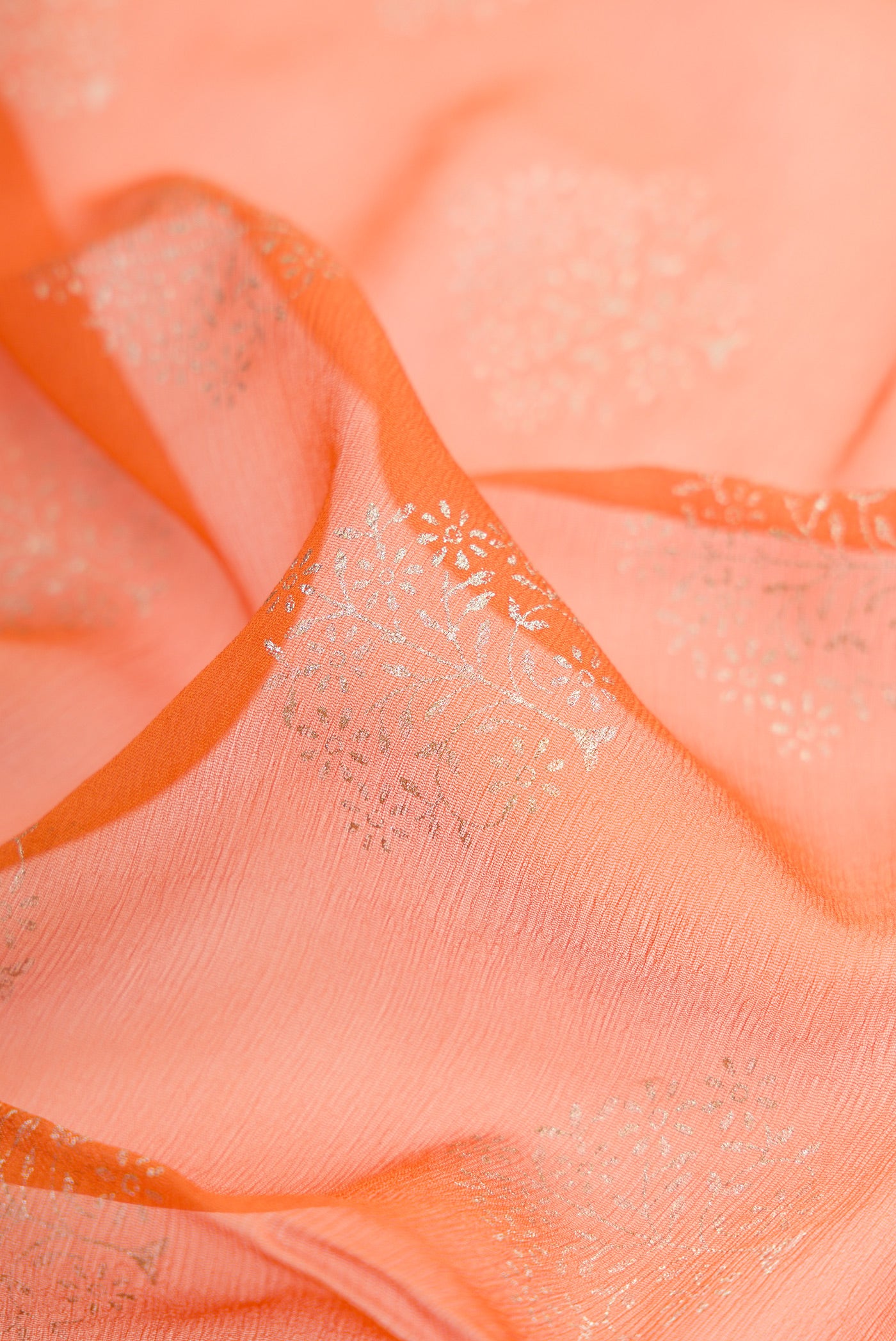 Close up of Mustard Mysore Chiffon Saree with Printed design on the body and Zari Border.  displaying folds