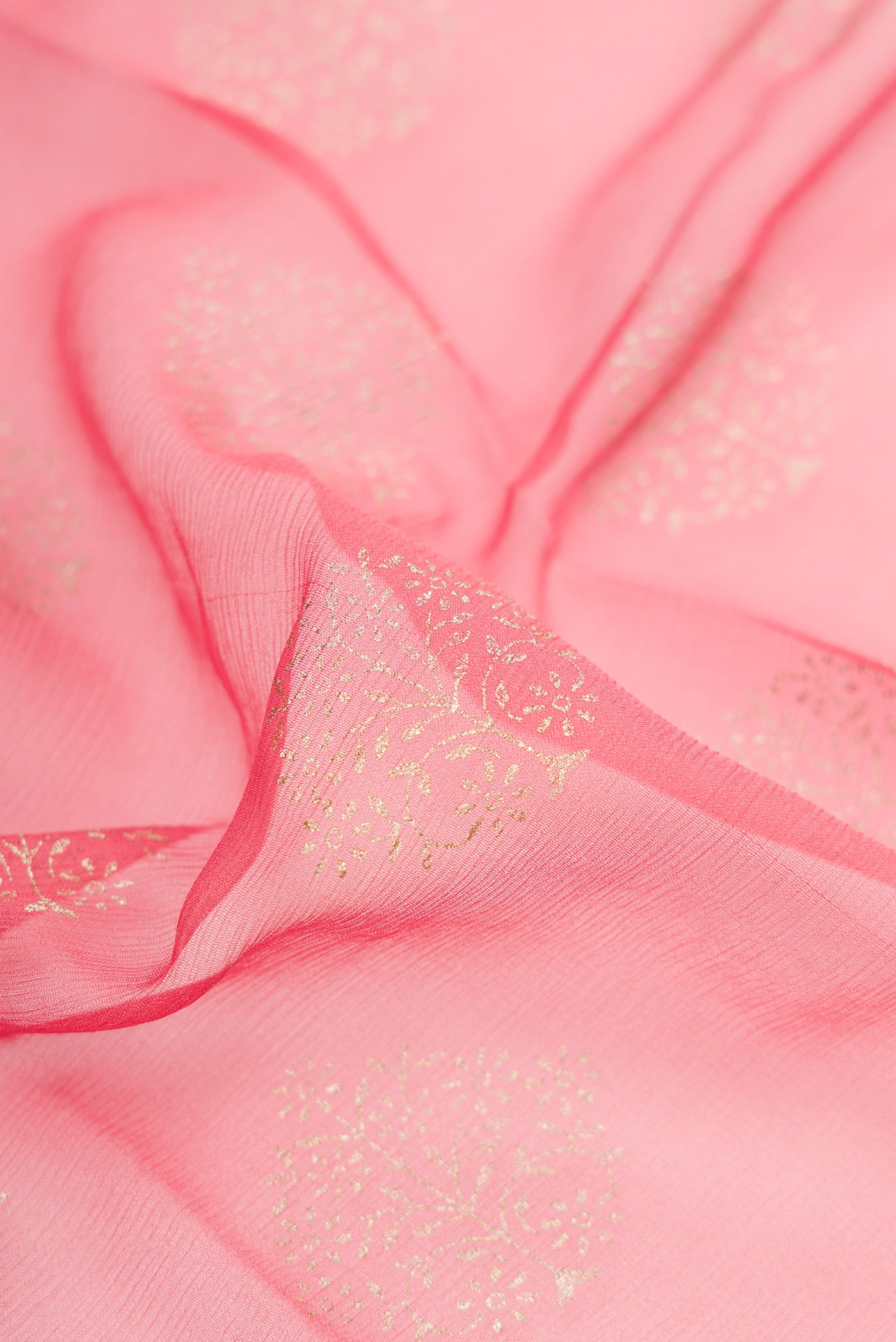 Close up of Pink Dual Tone Mysore Chiffon Saree with Zari Butta on the body and Zari Border.  displaying folds