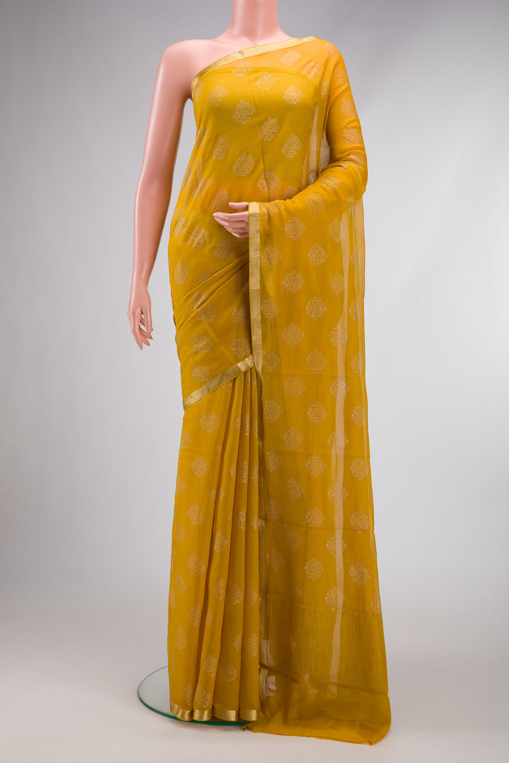 Yellow Dual Tone Mysore Chiffon Saree with Printed design on the body and Zari Border.  displayed on a mannequin