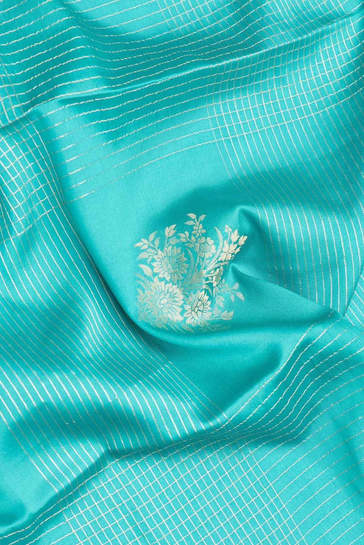 Close up of Sky Blue Dual Tone Mysore Crepe Saree with Checked design on the body and Zari And Thread Border.  displaying folds