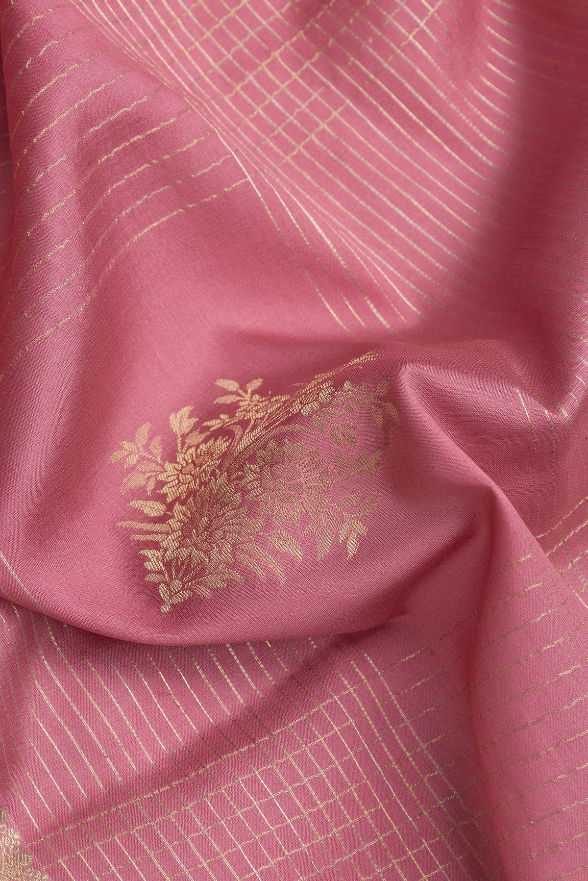 Close up of Pink Dual Tone Banarasi Georgette Saree with Checked design on the body and Zari And Thread Border.  displaying folds