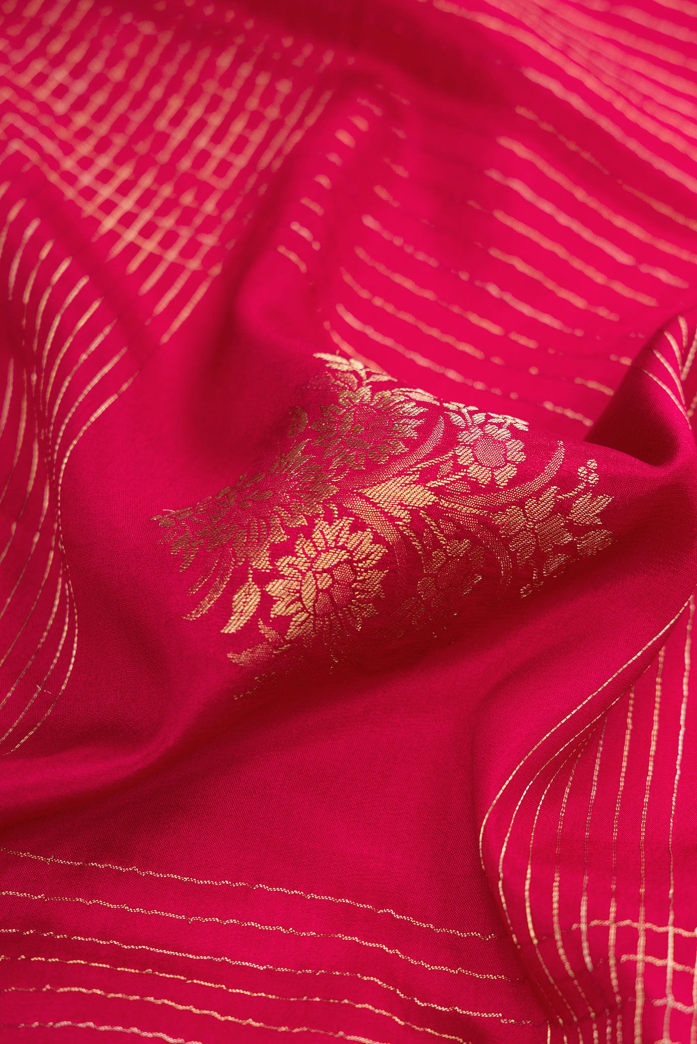 Close up of Red Dual Tone Mysore Crepe Saree with Checked design on the body and Zari Border.  displaying folds