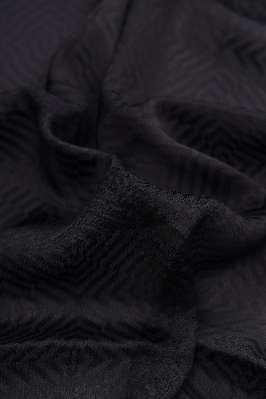 Close up of Black Dual Tone Mysore Georgette Saree with Jacquard design on the body and Zari Border.  displaying folds